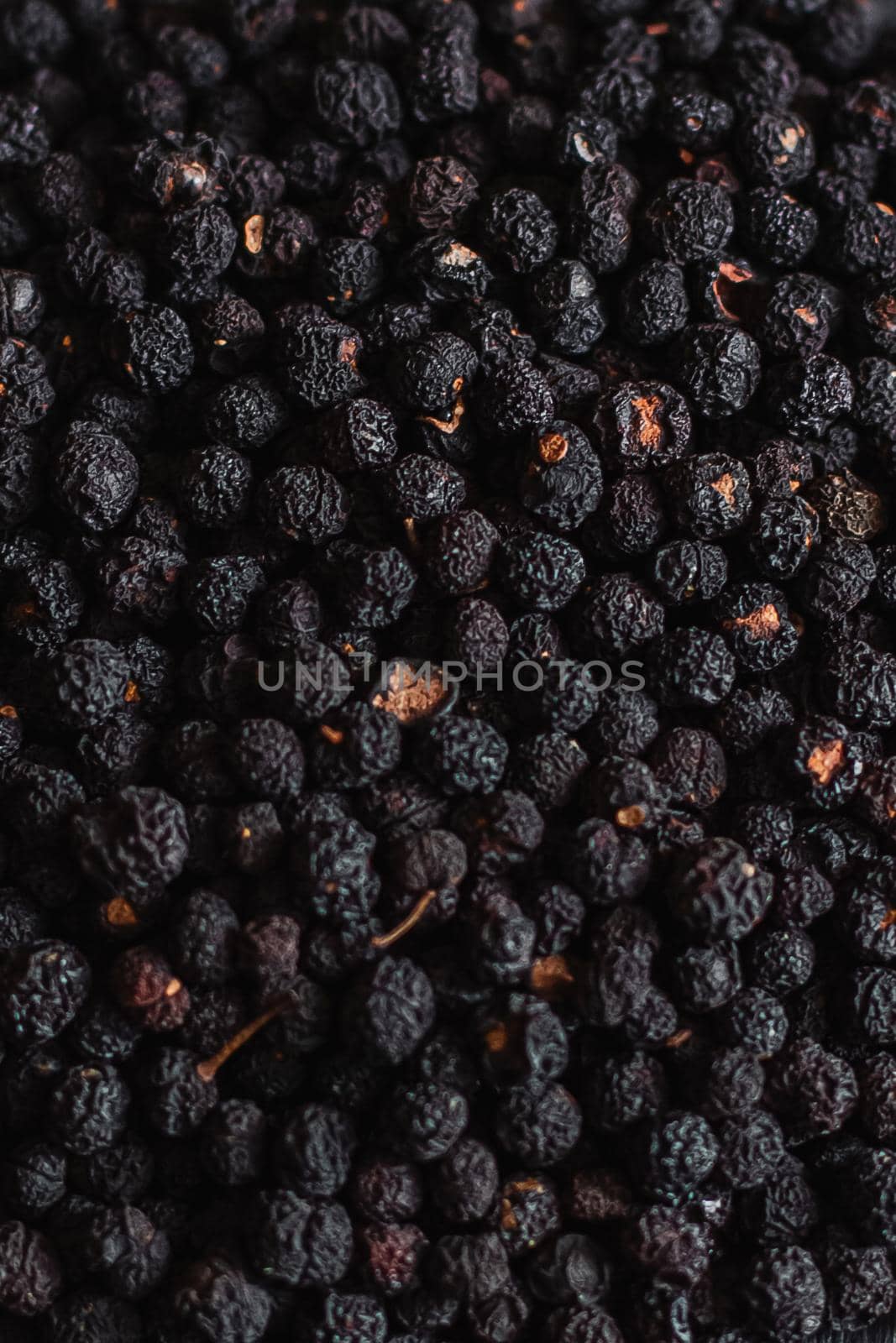 Black pepper grains, peppercorns seeds on a background close up macro