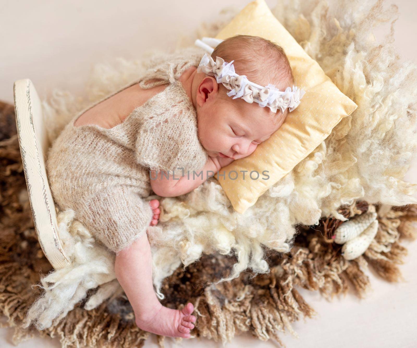 Sweet newborn baby on wool rug, sleeping in peace