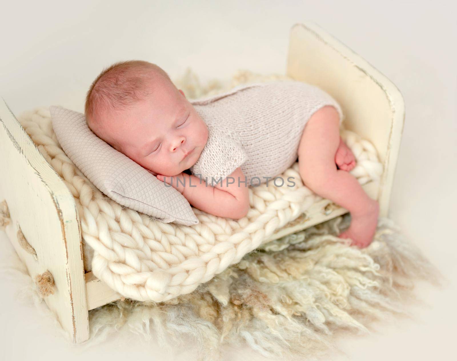 cute newborn baby girl sleeping in a little bed