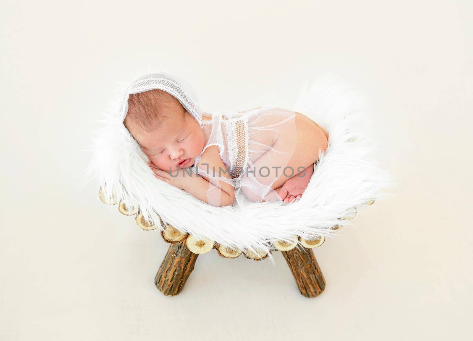 cute newborn baby girl sleeping in a little bed