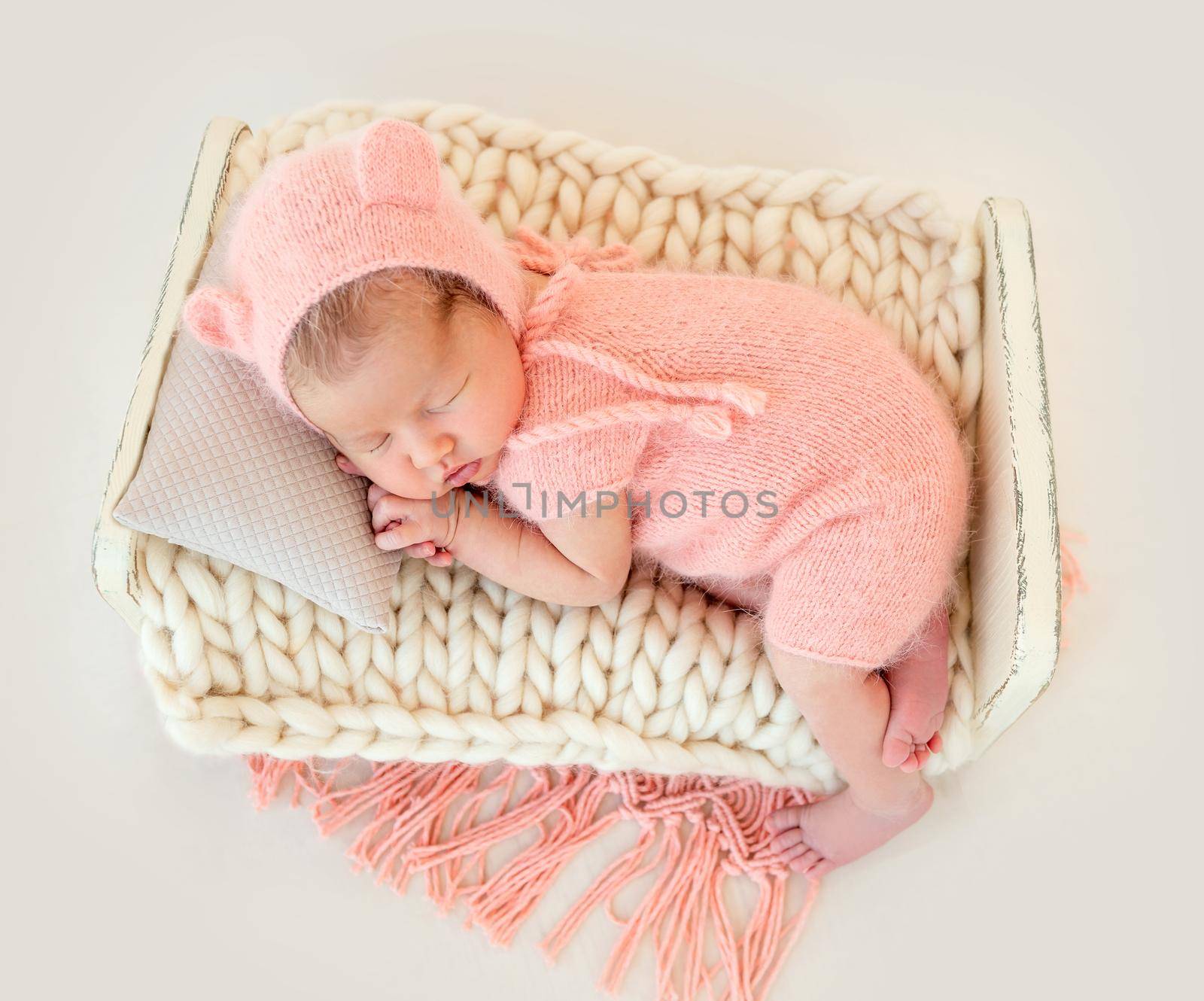 cute newborn baby girl sleeping in a little bed