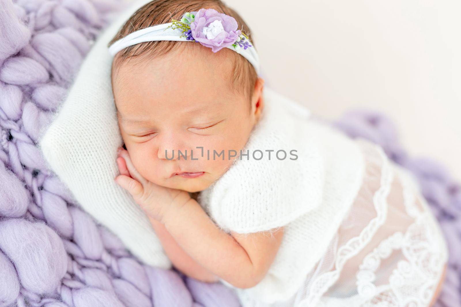 cute newborn baby girl sleeping in a little bed