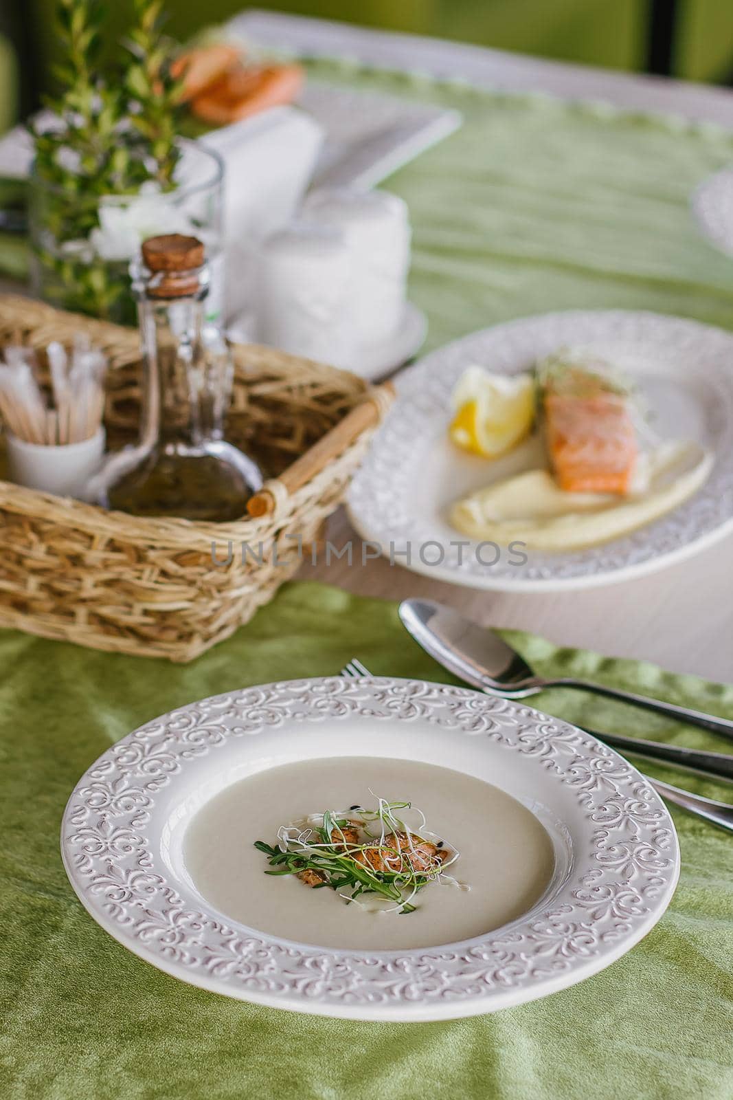 Cheese soup with salmon in green interior background.
