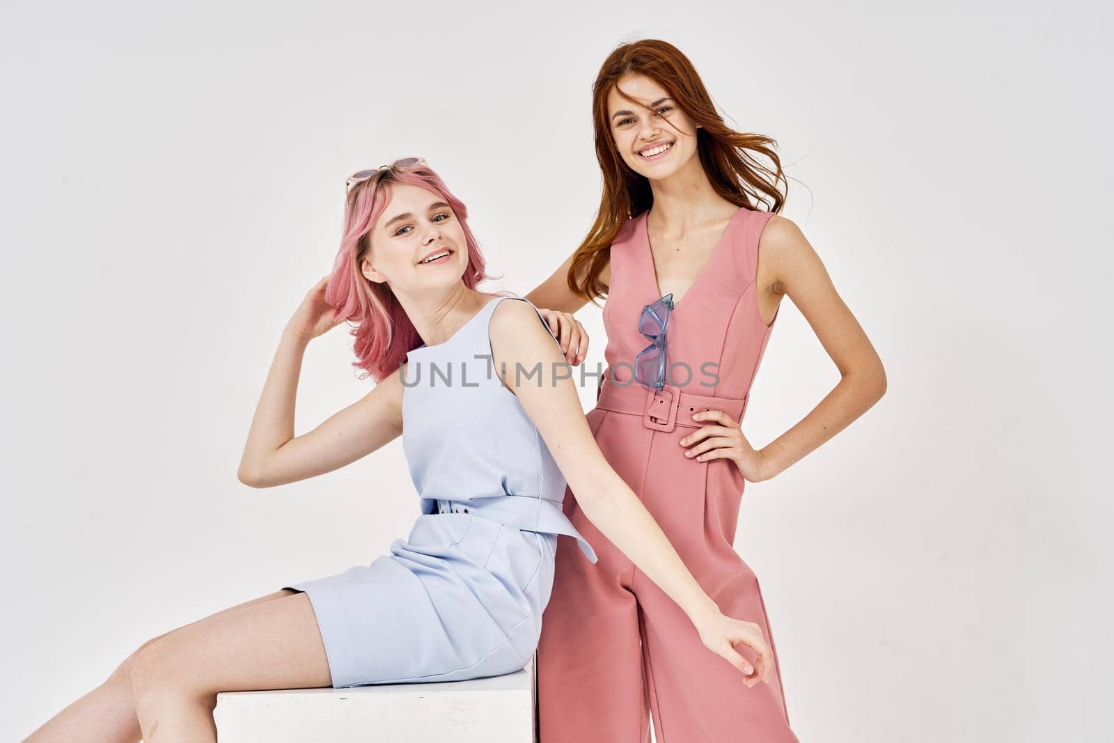 two women in fashionable clothes posing model decoration. High quality photo