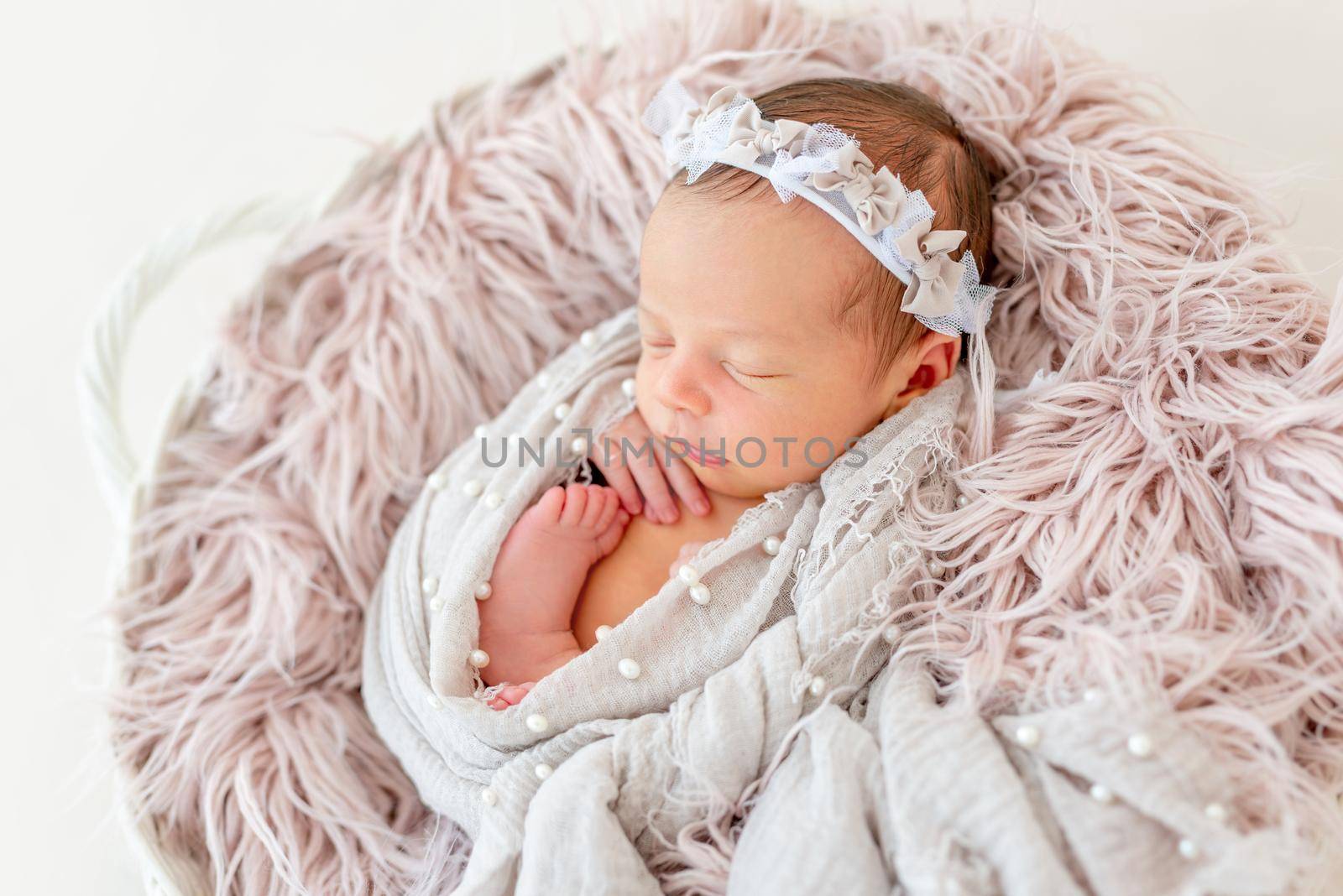 newborn baby girl sleeping sweetly in the basket