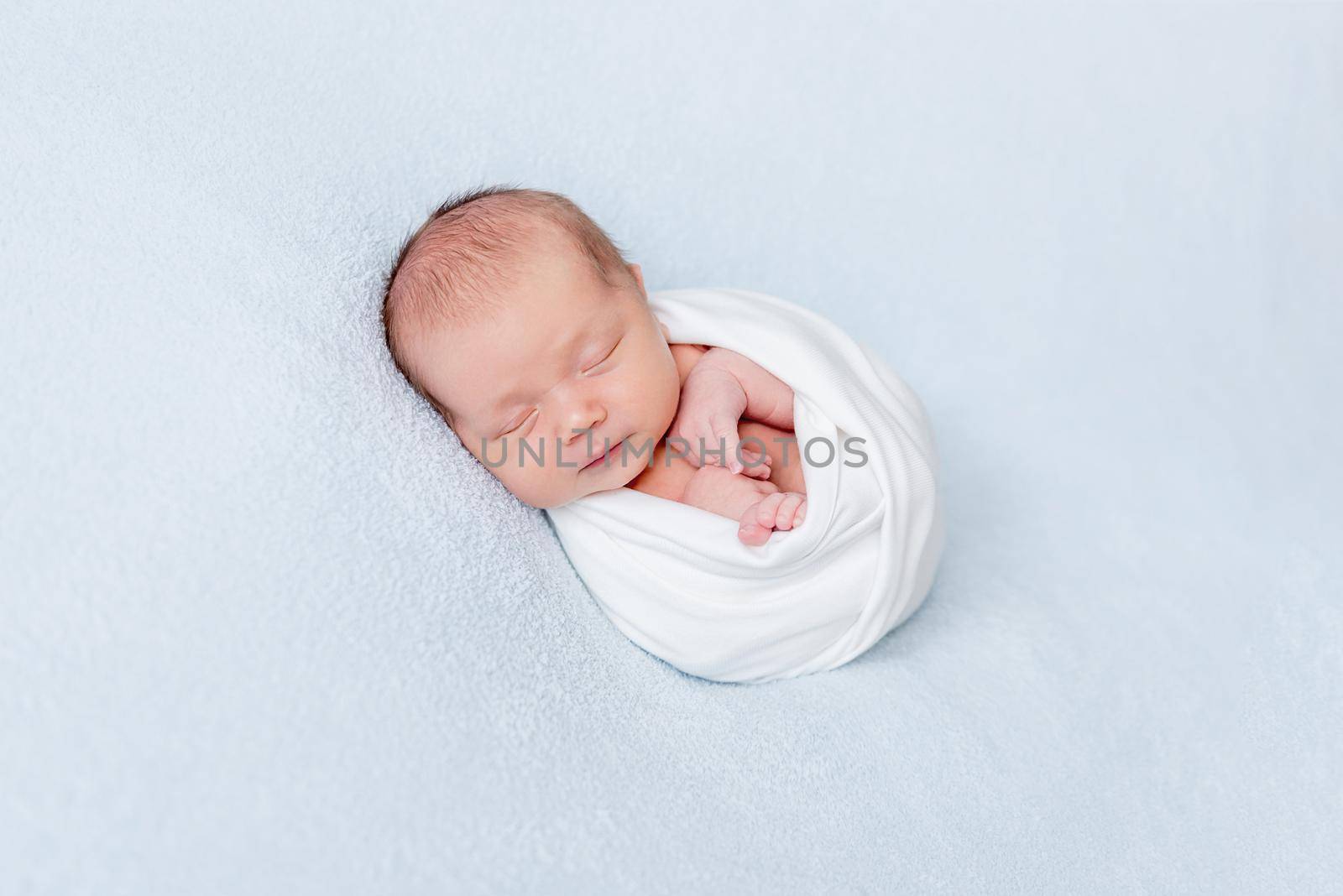 Newborn baby sleeping swaddled in blanket by tan4ikk1