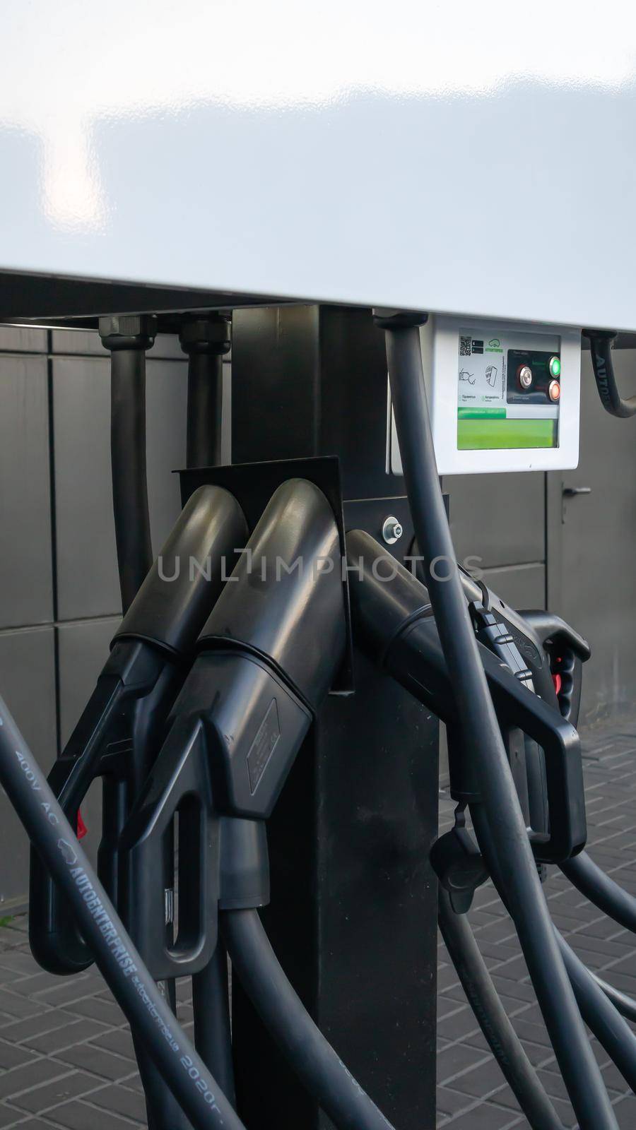 Public charging station for electric vehicles in the parking lot. Charger for public electric vehicles located in the parking lot. Ukraine, Kiev - June 14, 2021