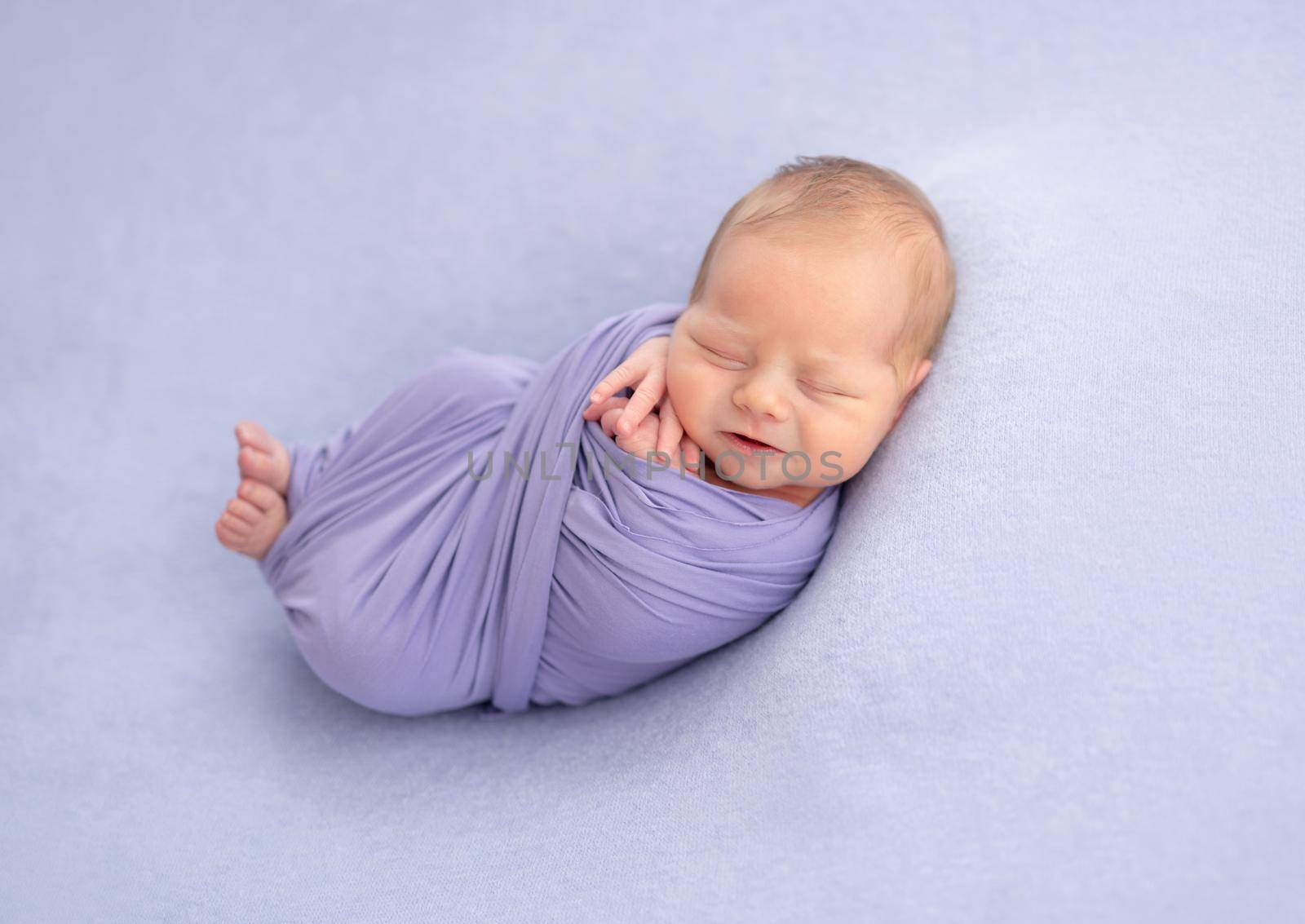 Charming newborn baby wrapped in blanket