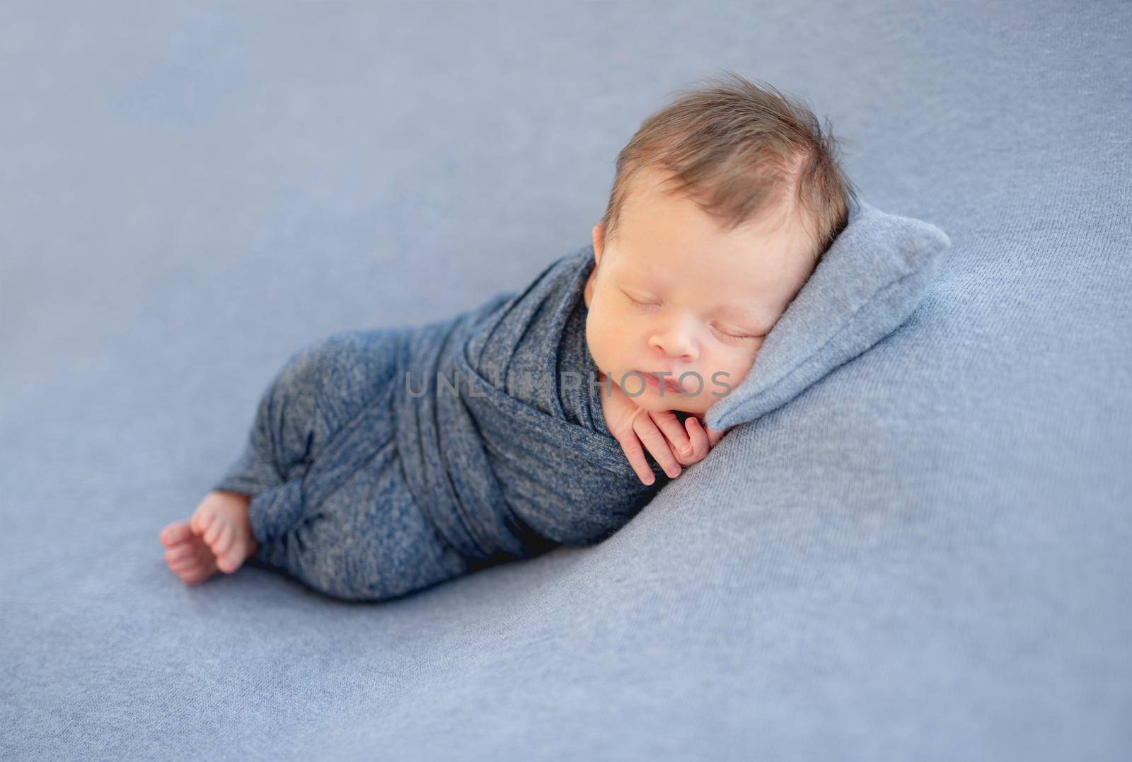 Sweet newborn sleeping on tiny pillow