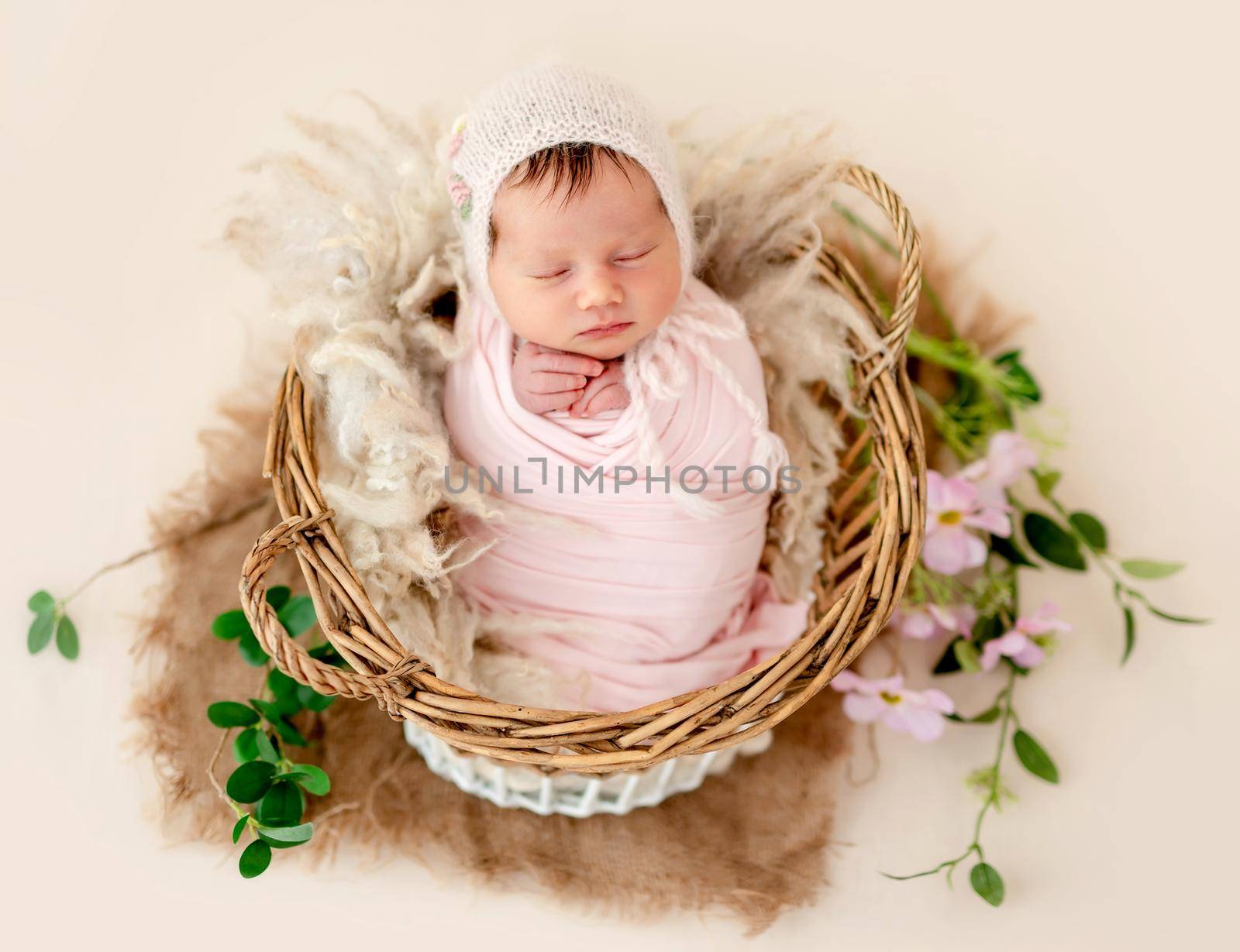 Beautiful newborn sleeping in decorated basket