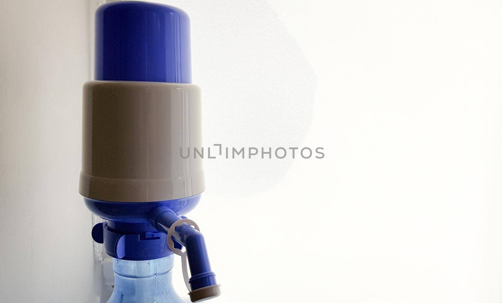 pump on a water bottle. Close-up on a white background.