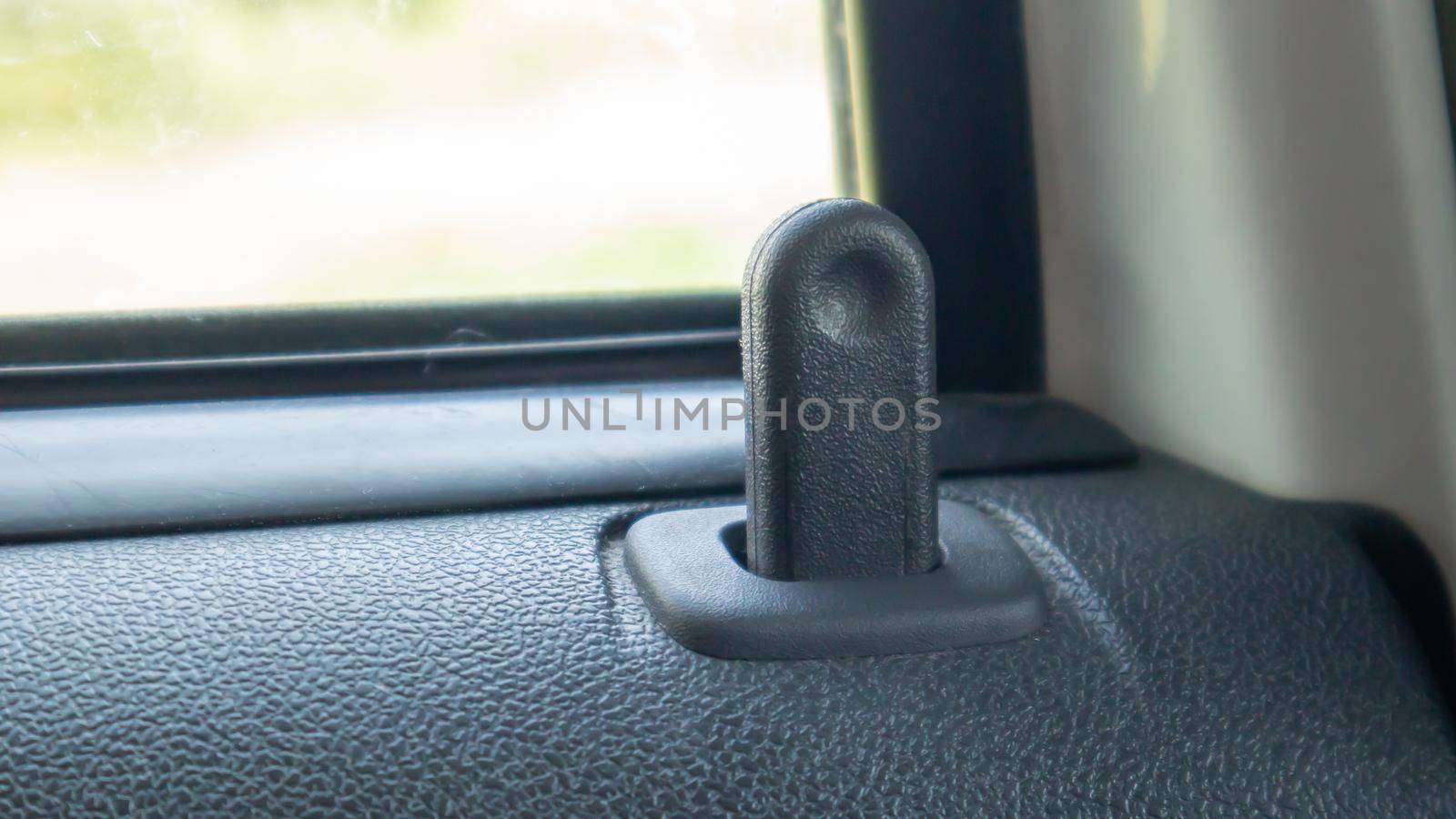 Close the lock button for the interior door of the vehicle. Door lock button inside the car interior close-up