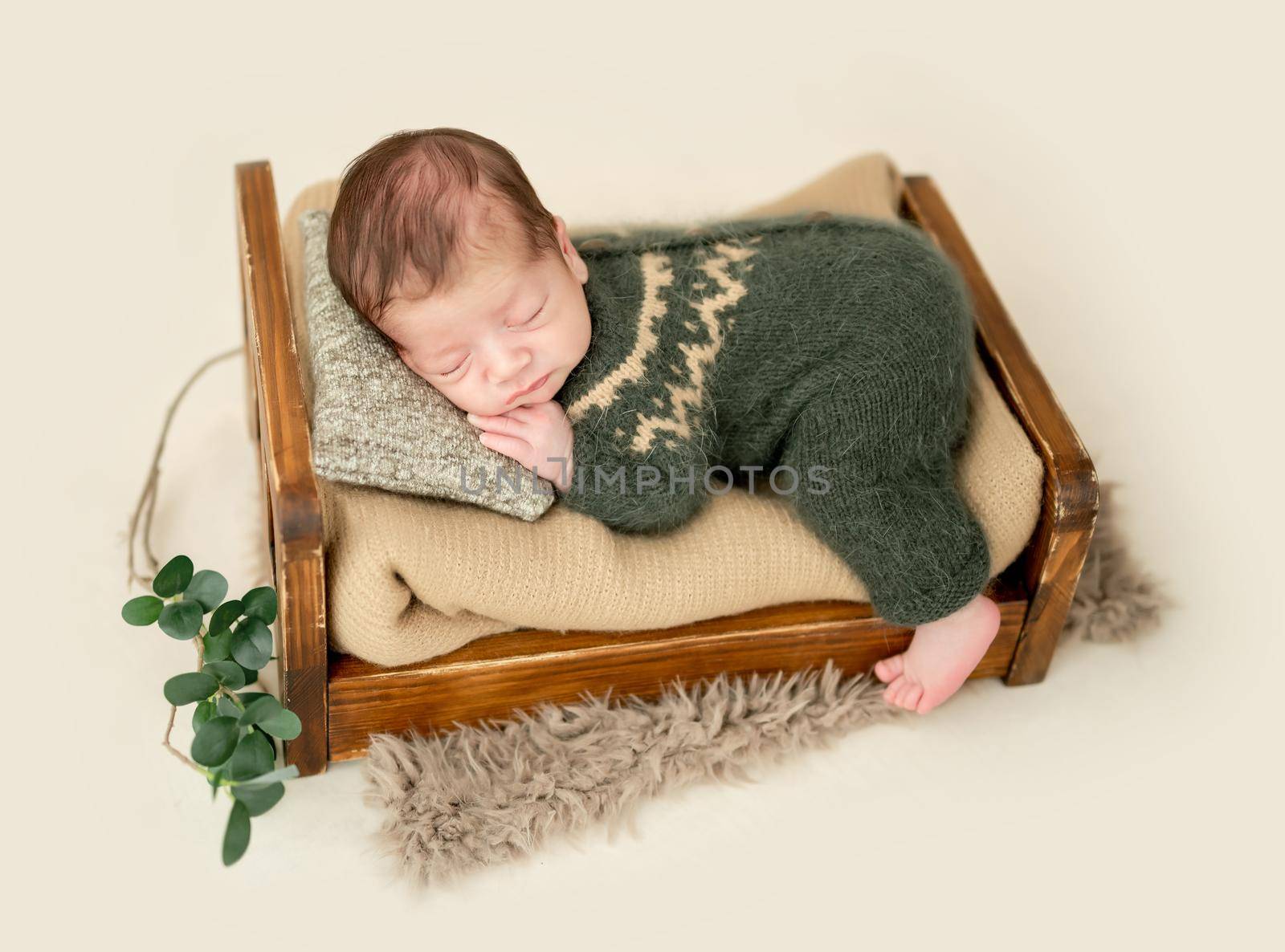 Lovely newborn sleeping on tiny bed