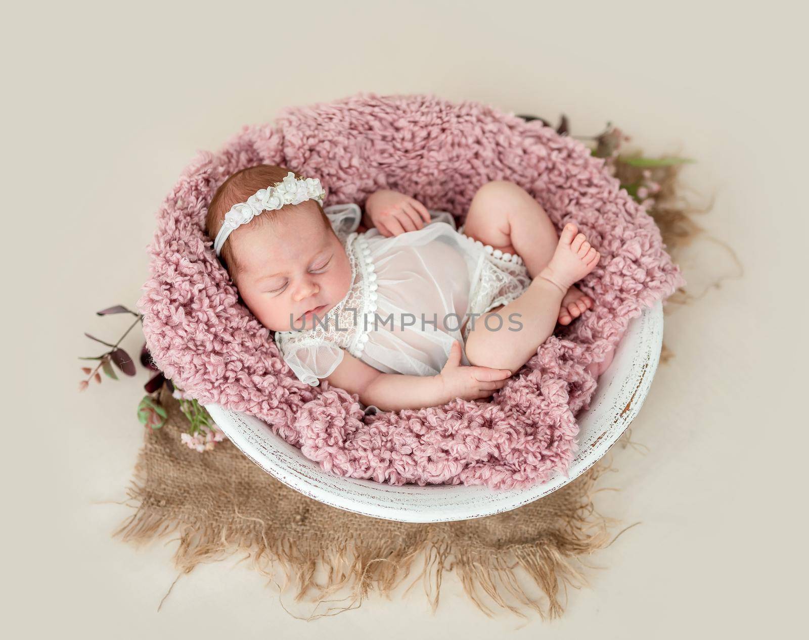 Lovely newborn sleeping with knitted toy