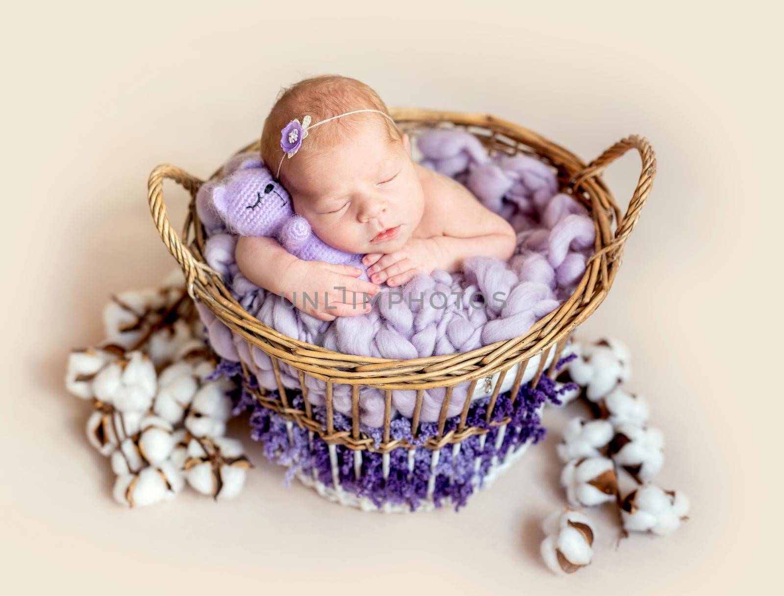Funny little new born girl hugging teddy bear, close up
