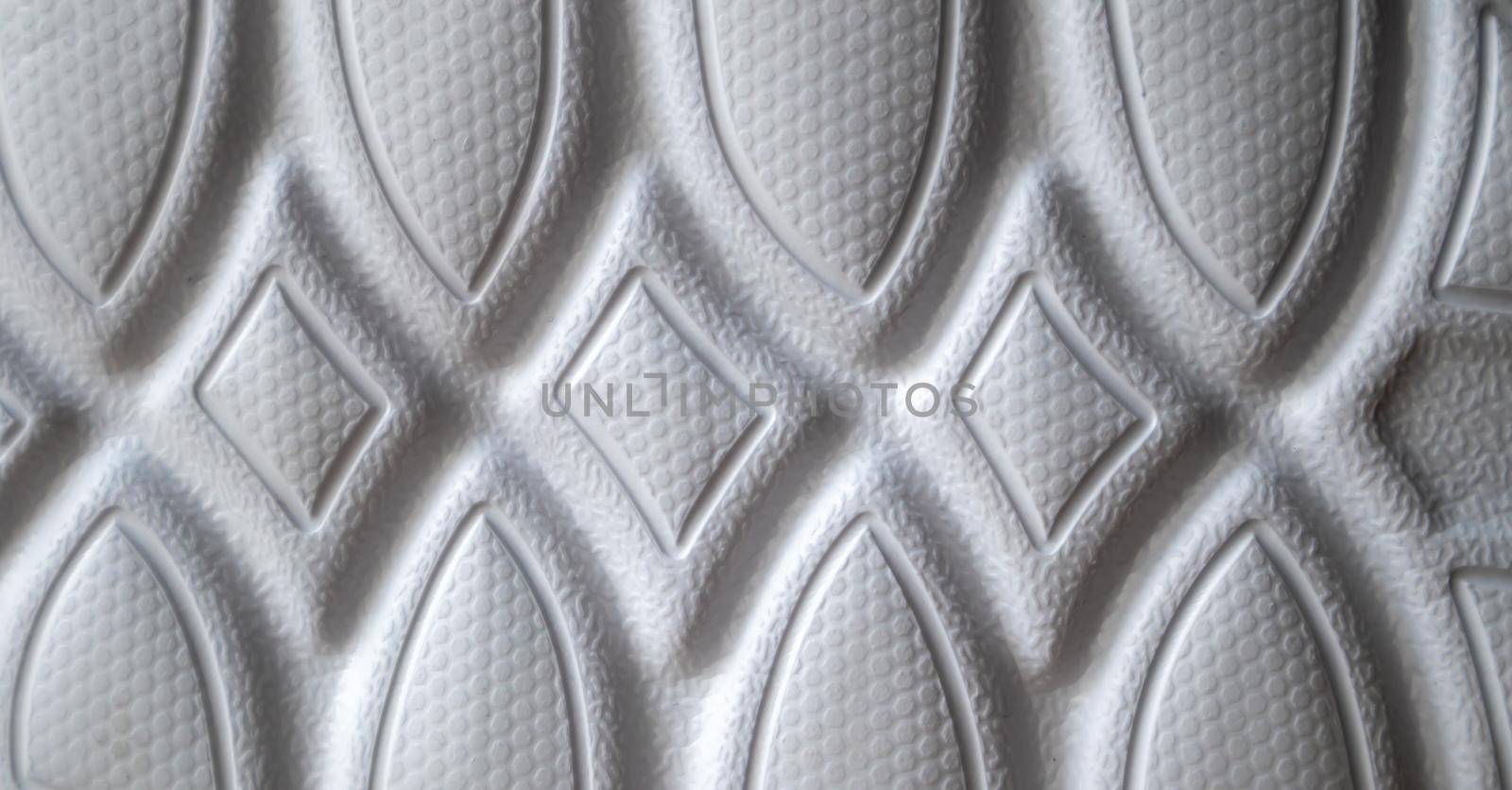 The outsole of new white sneakers. Rubber sole for men's shoes. Sole for sports and walking shoes. The texture of the material of sports shoes.