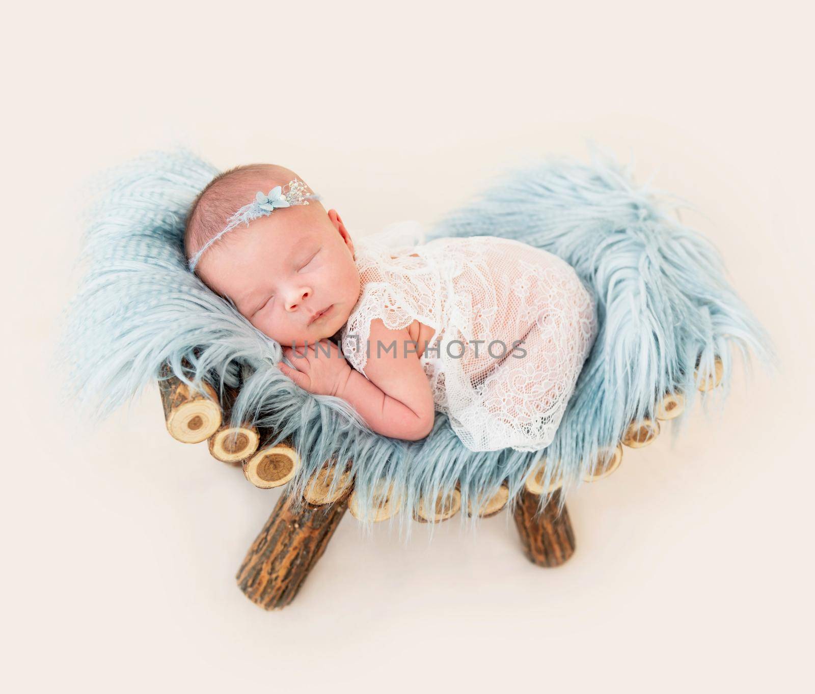 cute newborn baby girl sleeping in a little bed