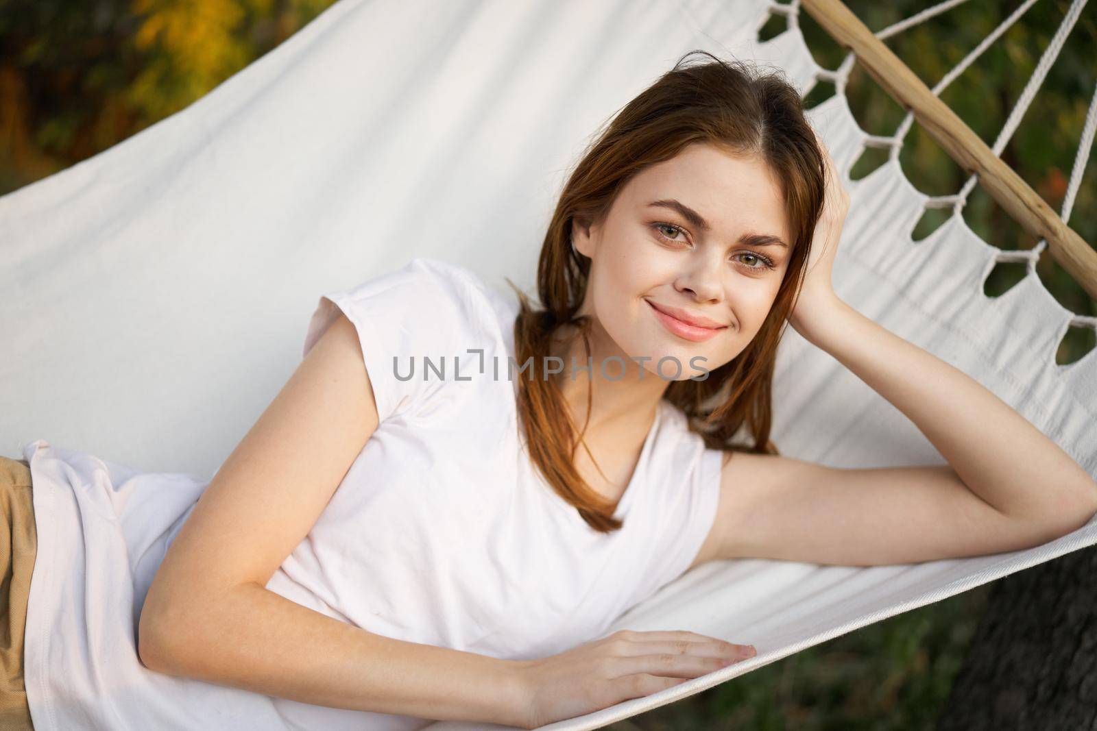 cheerful woman lies in a hammock rest nature fresh air. High quality photo