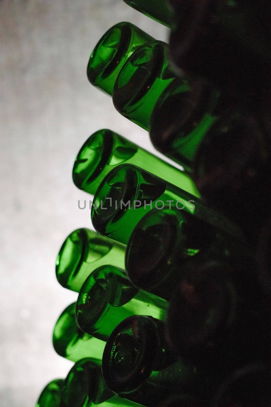 Green bottles of wine or champagne. Champagne production.