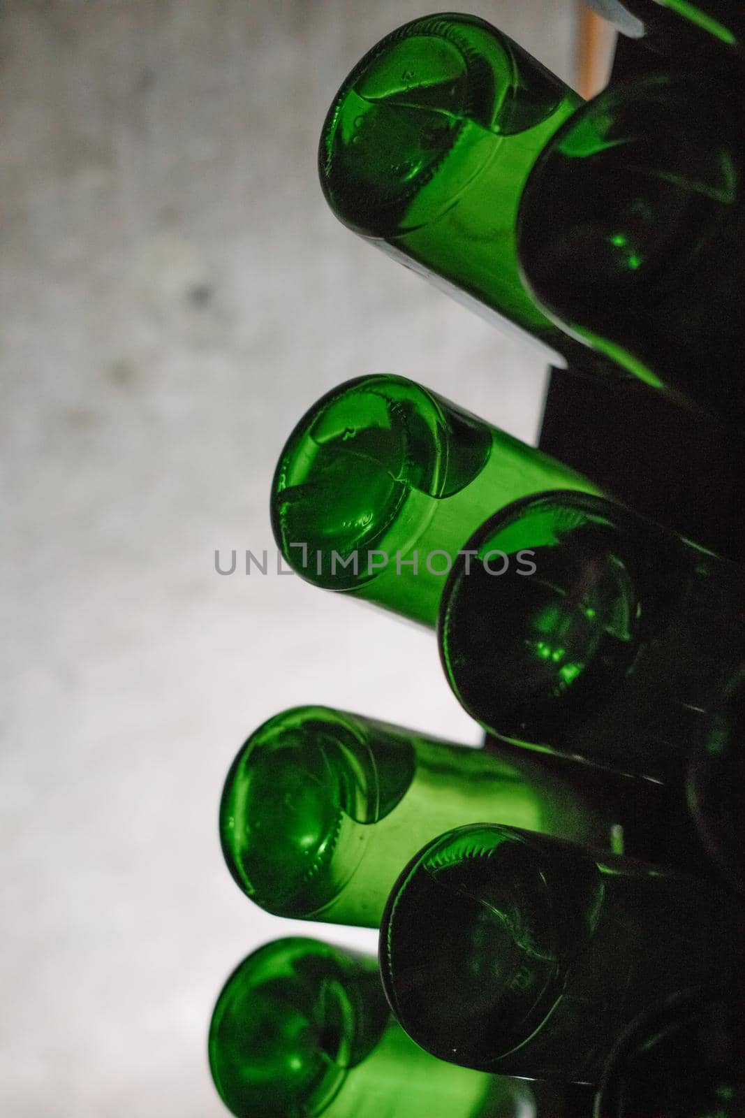 Green bottles of wine or champagne. Champagne production.