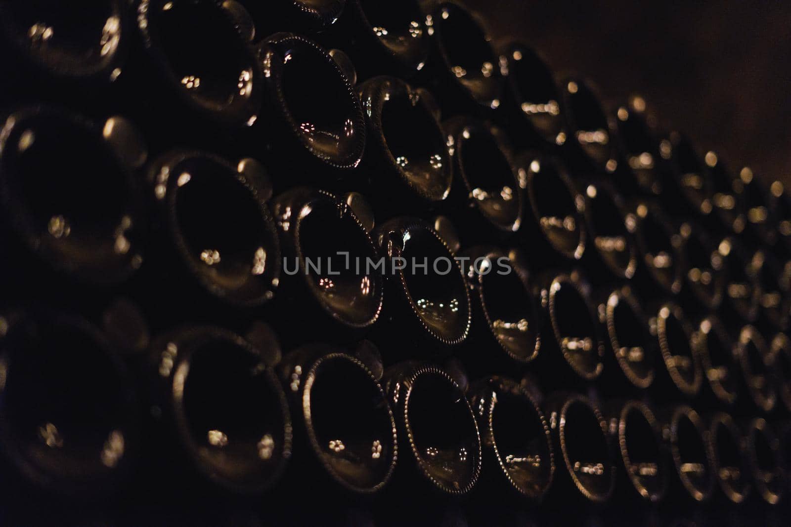 Green bottles of wine or champagne. Champagne production.