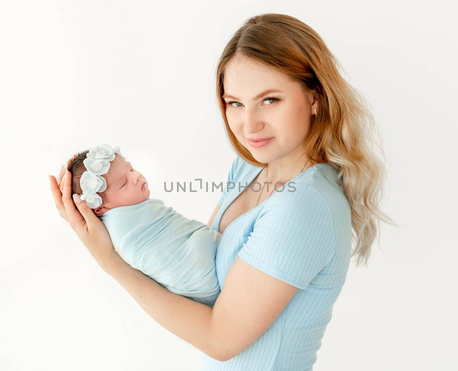 young beautiful mother holding a newborn daughter by tan4ikk1