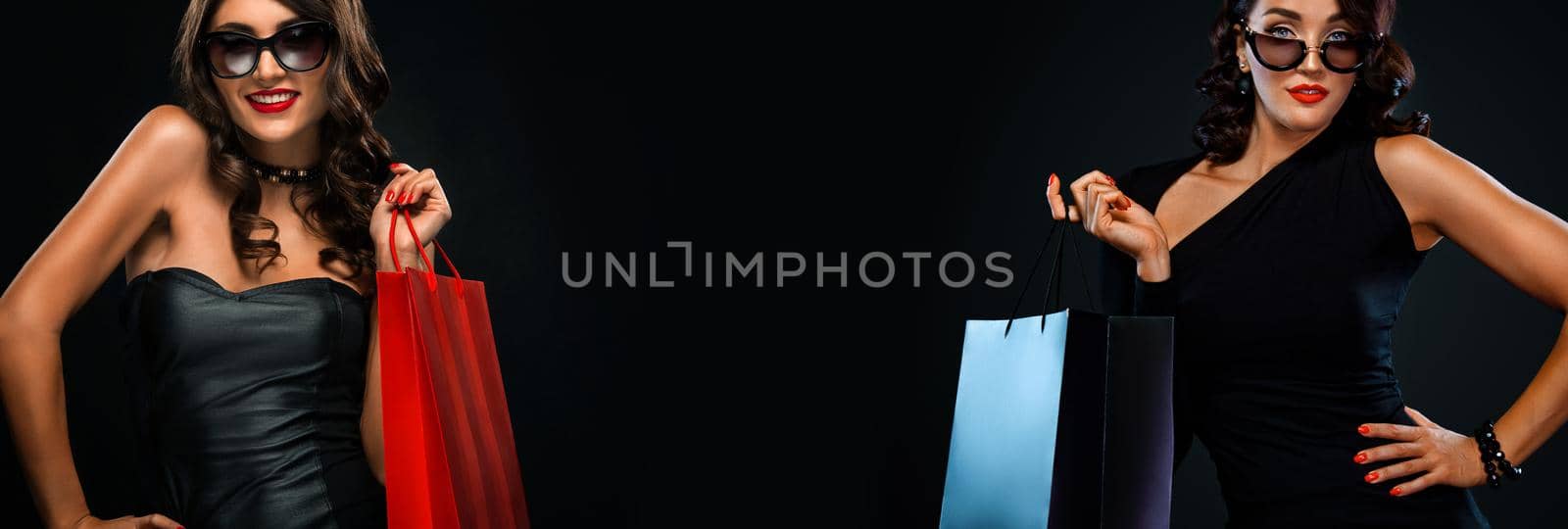 Beautiful young woman make shopping in black friday holiday. Girl with black bag on dark background.