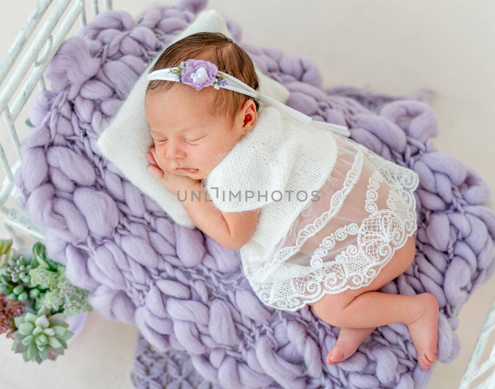 cute newborn baby girl sleeping in a little bed