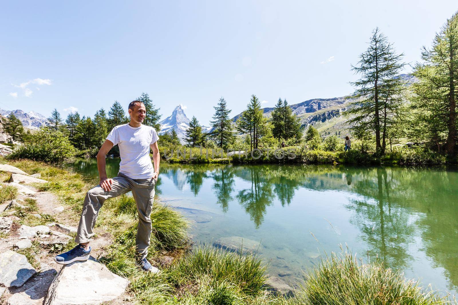 man in the mountains of switzerland, the view of the Alps.