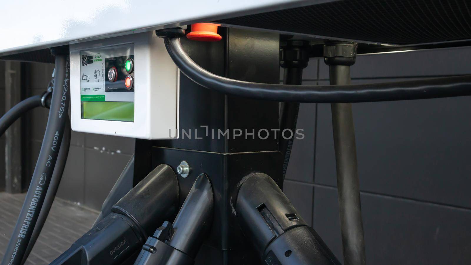 Public charging station for electric vehicles in the parking lot. Charger for public electric vehicles located in the parking lot. Ukraine, Kiev - June 14, 2021