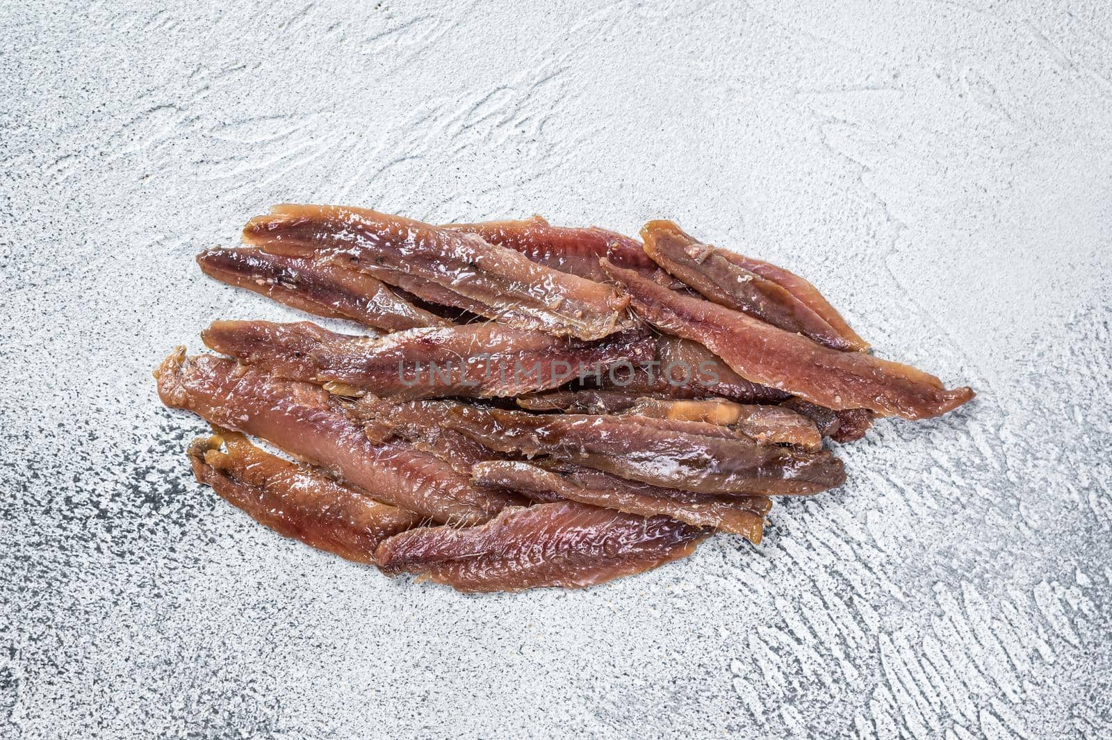 Canned Anchovies fish fillet in Olive Oil. White background. Top view.