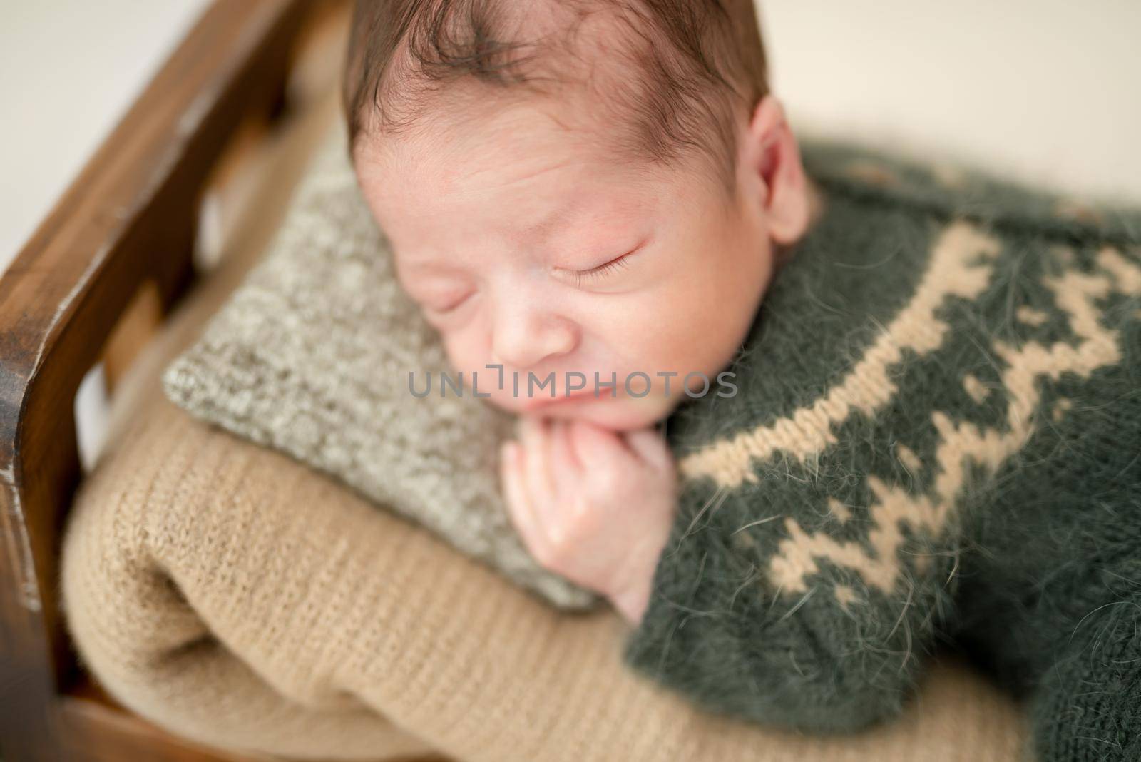 Lovely newborn sleeping on tiny bed