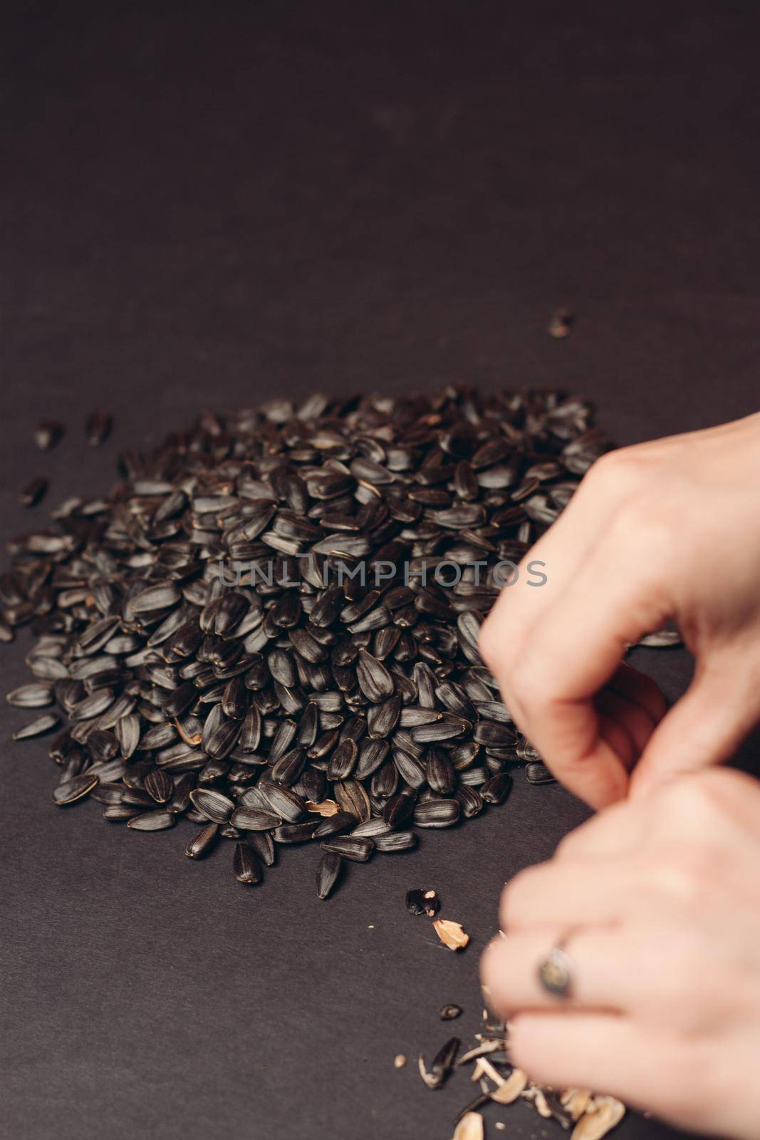 natural product sunflower seeds handing close-up food by Vichizh