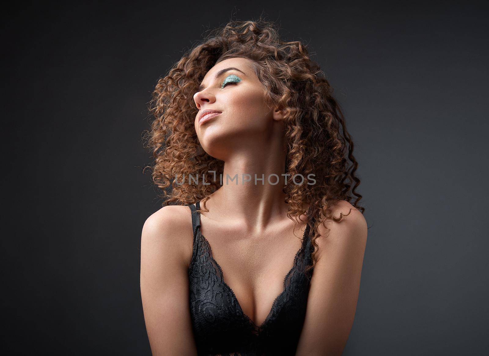 Portrait of a beautiful female fashion model with curly hair by AliaksandrFilimonau
