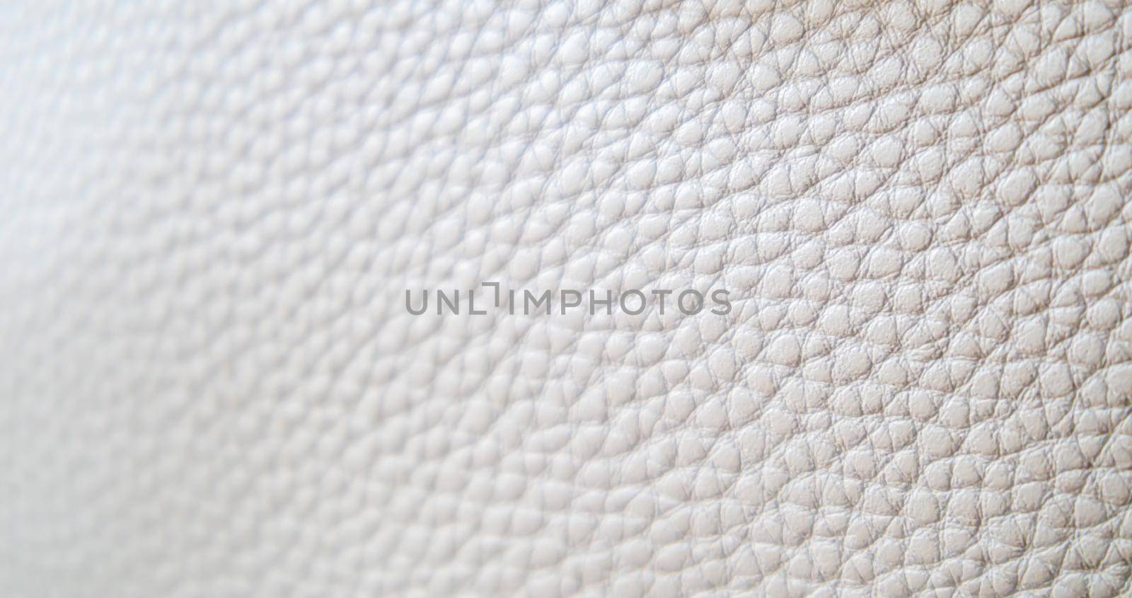 Leather texture background. Light beige ecru imitation leather sample. Abstract background with copy space, top view