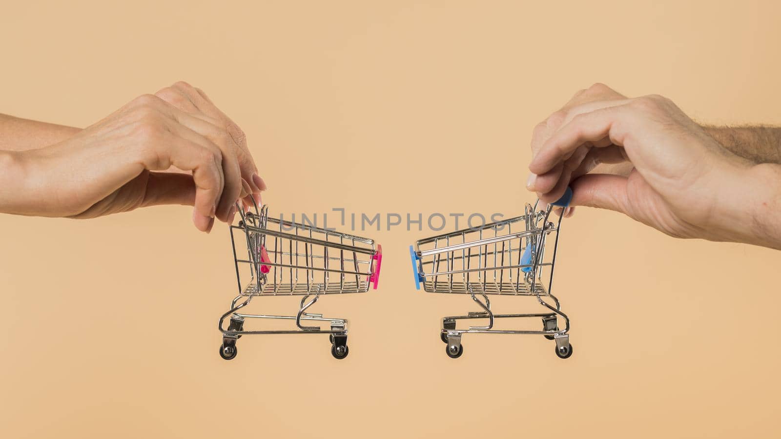 hands holding small shopping carts by Zahard