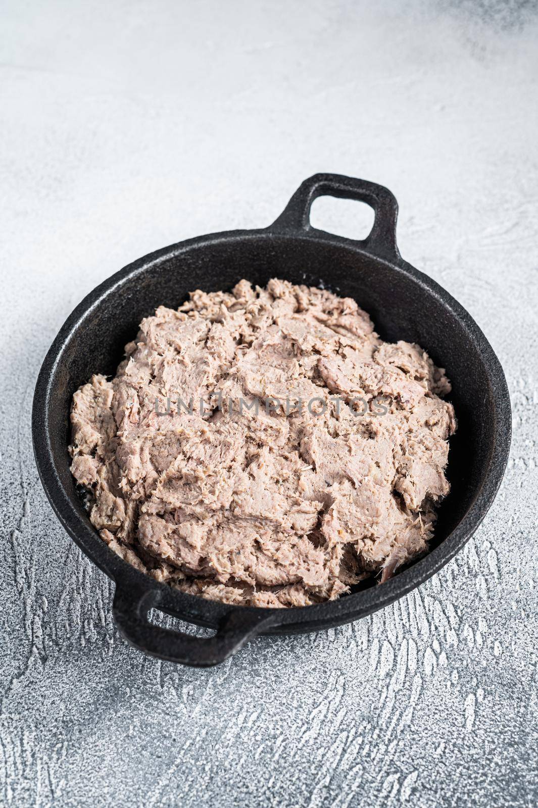 Duck pate Rillettes de Canard in a pan. White background. Top View. Copy space.