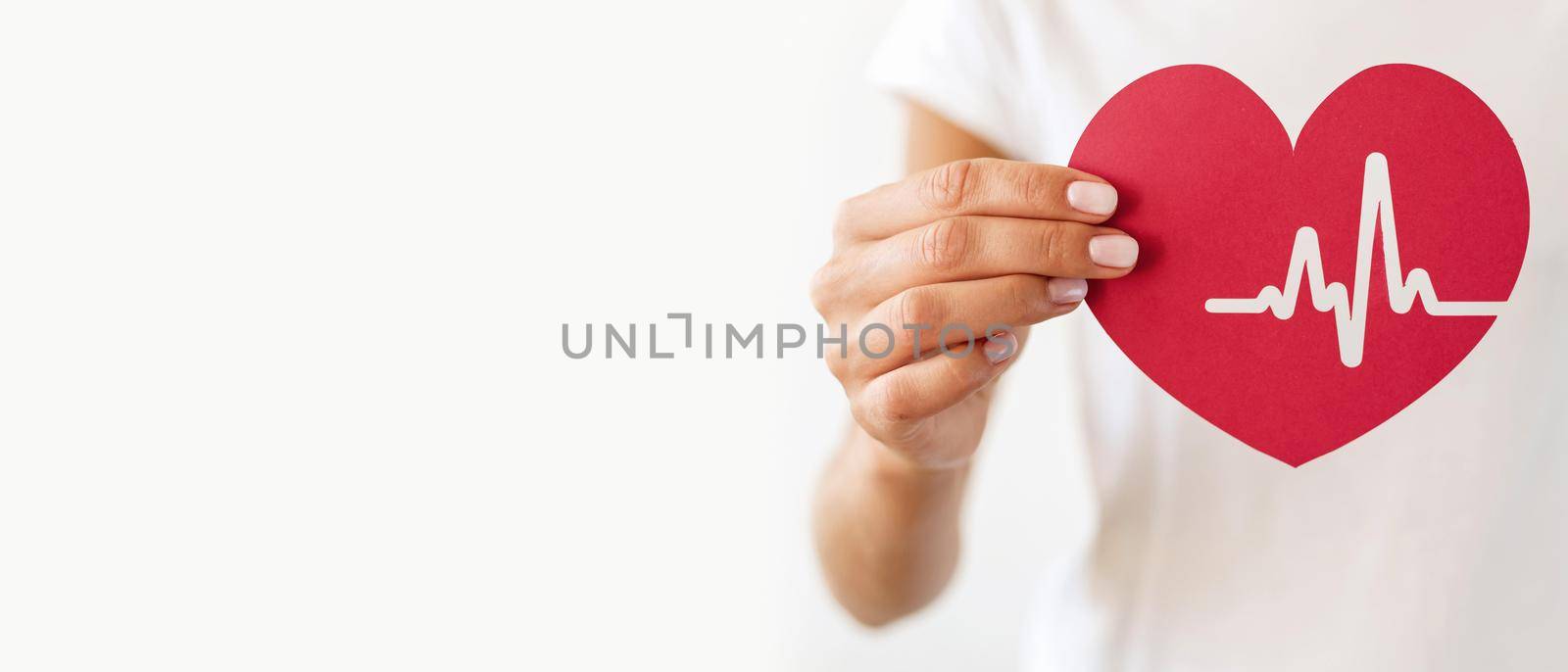 front view woman holding paper heart with heartbeat