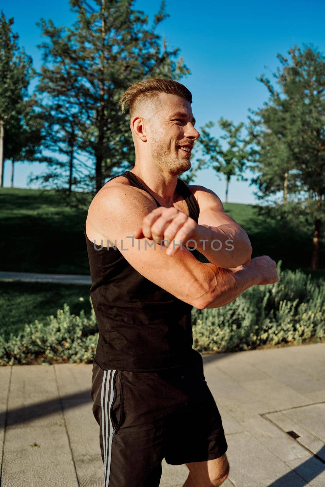 sporty man exercise fitness workout outdoors with dumbbells by Vichizh