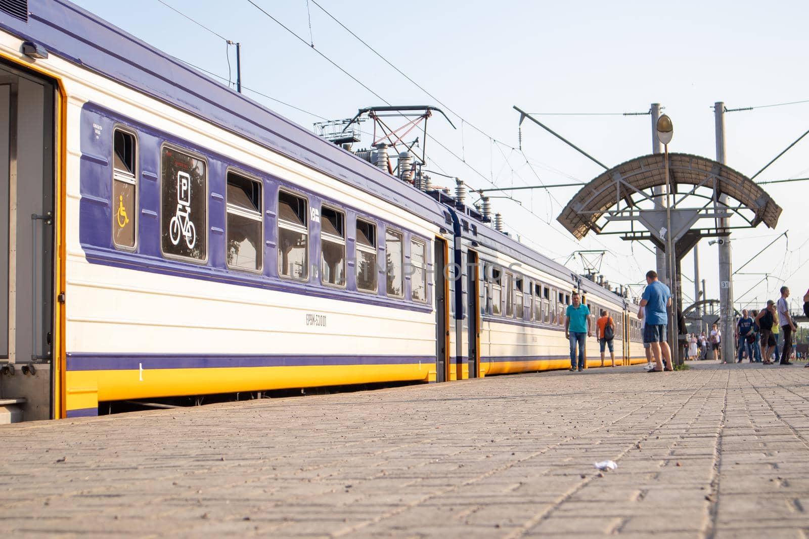 Electrical unit at the station. Passenger ring train. Kiev city train. A type of public transport in Kiev, running on a circular route within the Kiev railway junction. Ukraine, Bucha - June 28, 2021