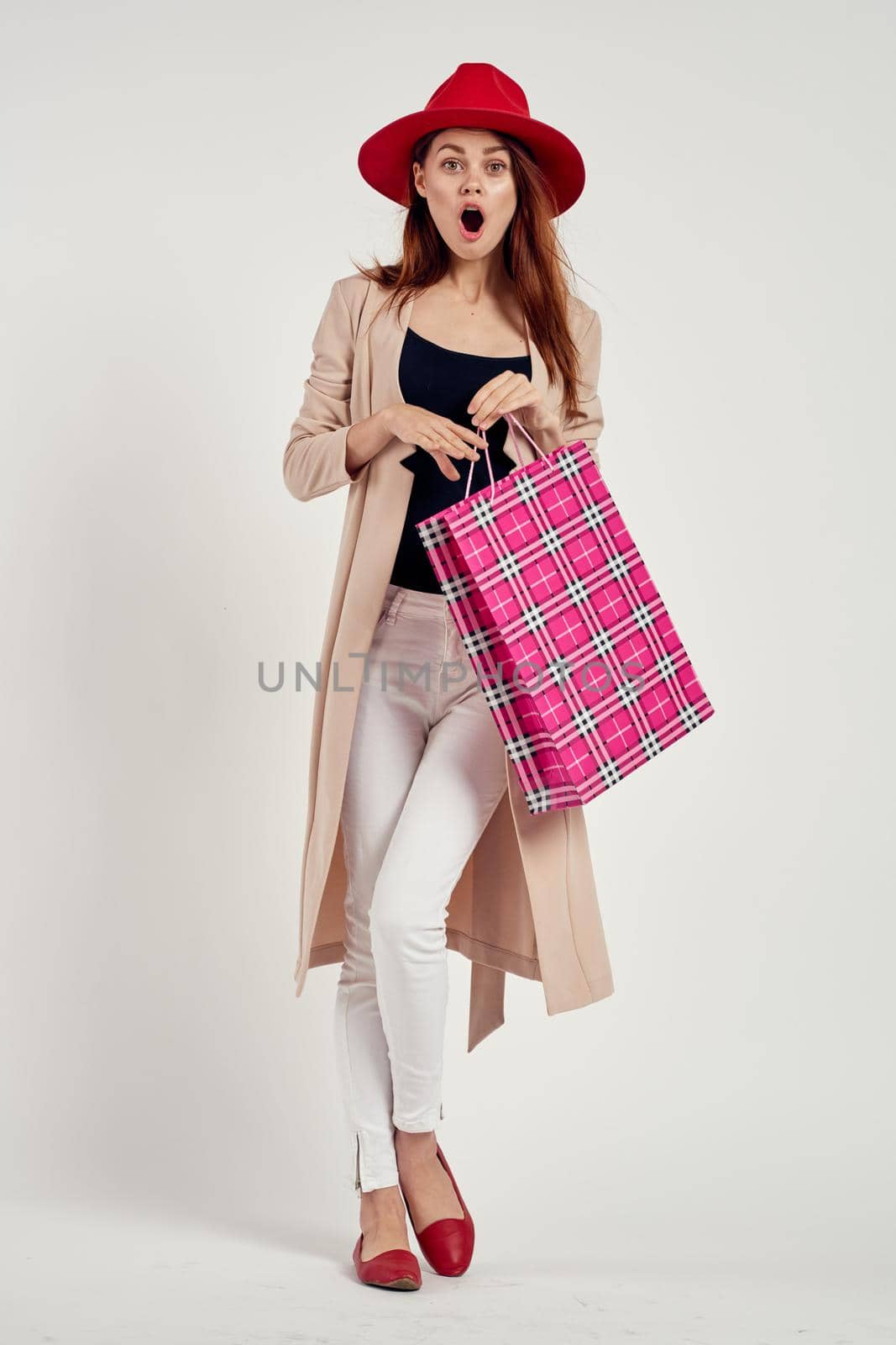 cheerful woman with packages in hands Shopaholic studio model. High quality photo