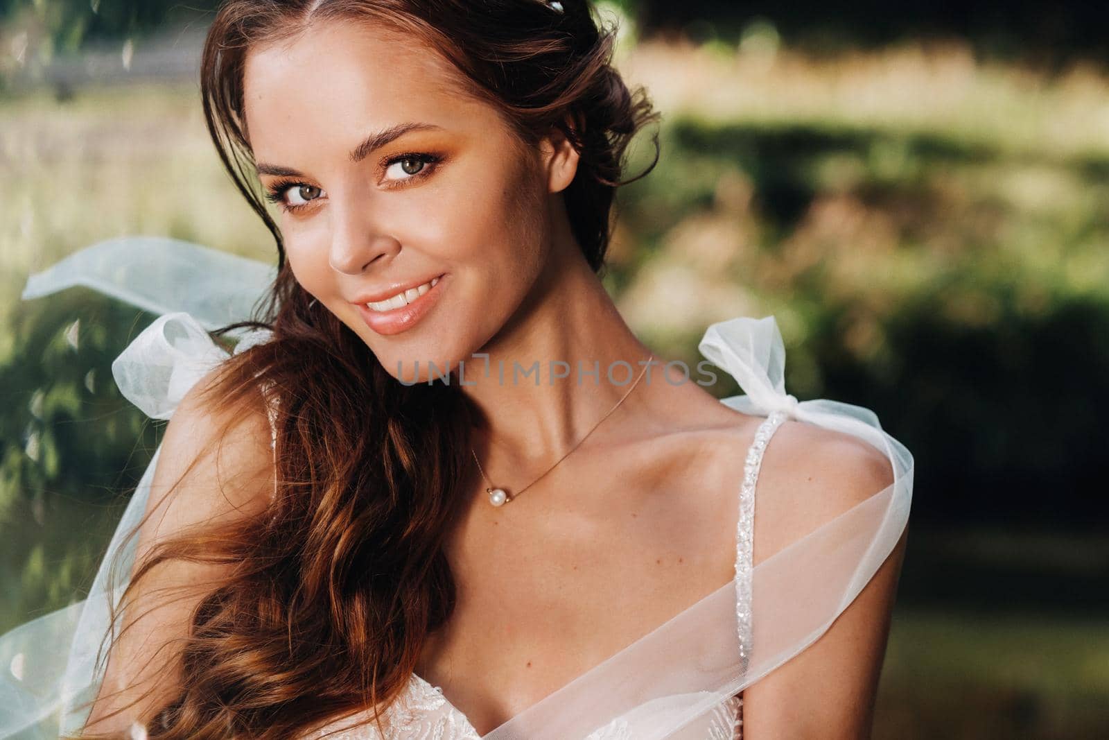 Close-up portrait of an Elegant bride in a white dress in nature in a nature Park.Model in a wedding dress and gloves .Belarus.