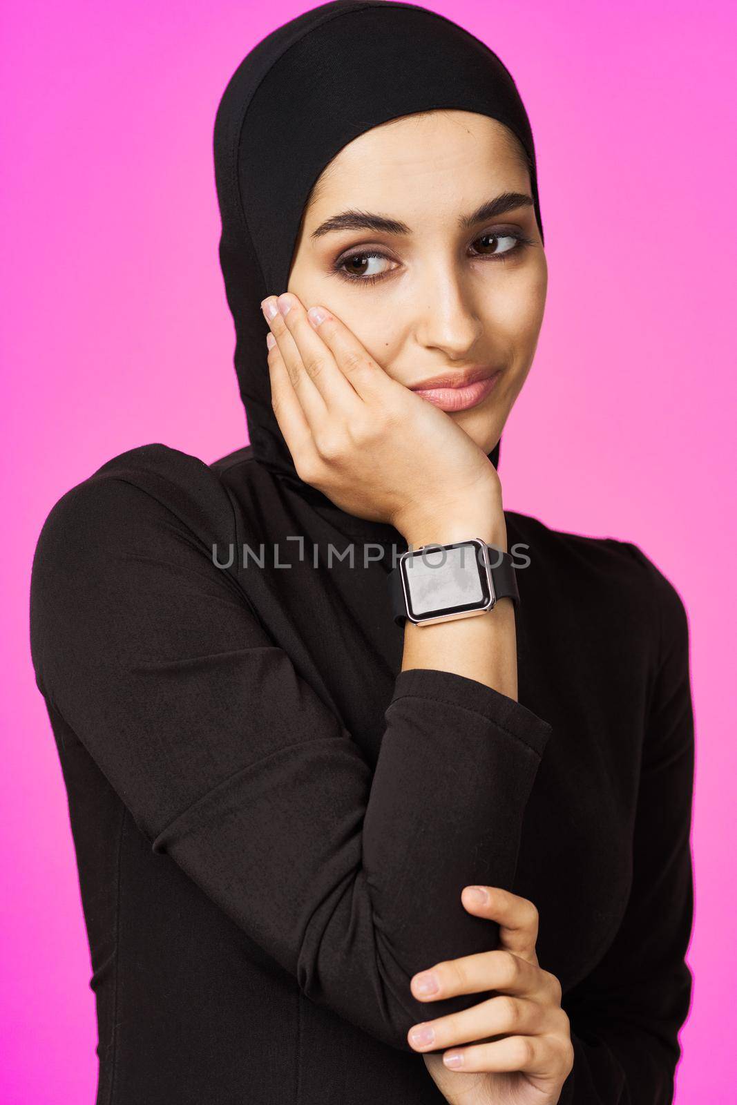 muslim woman in black hijab smart watch technology entertainment. High quality photo
