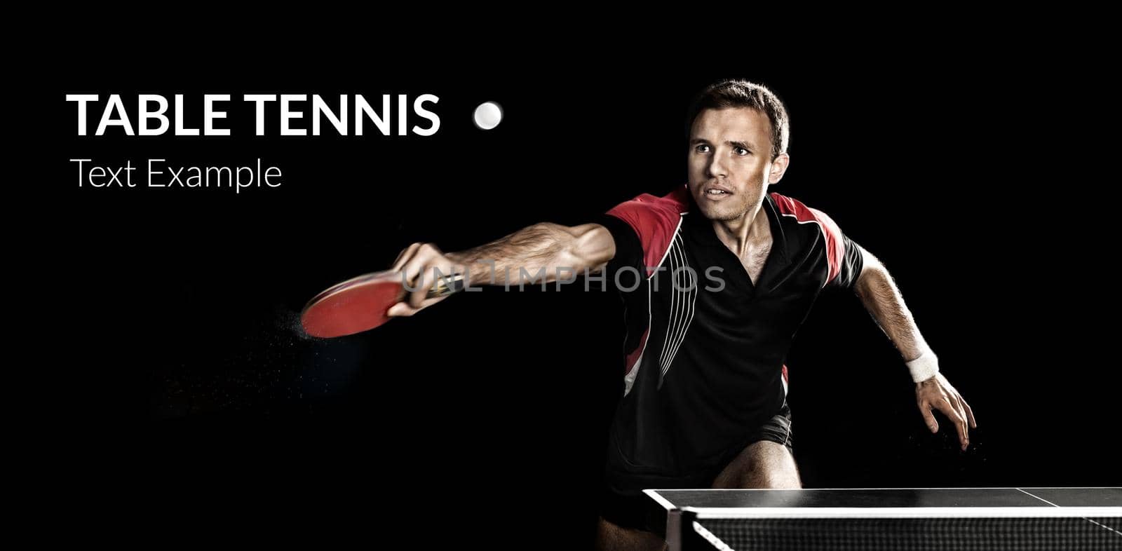 Portrait Of Young Man Playing Tennis On Black Background