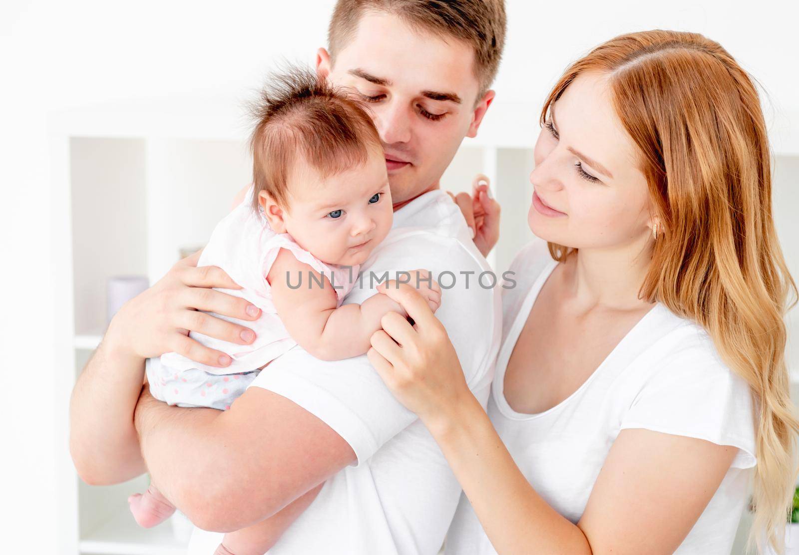 Adorable young family at home