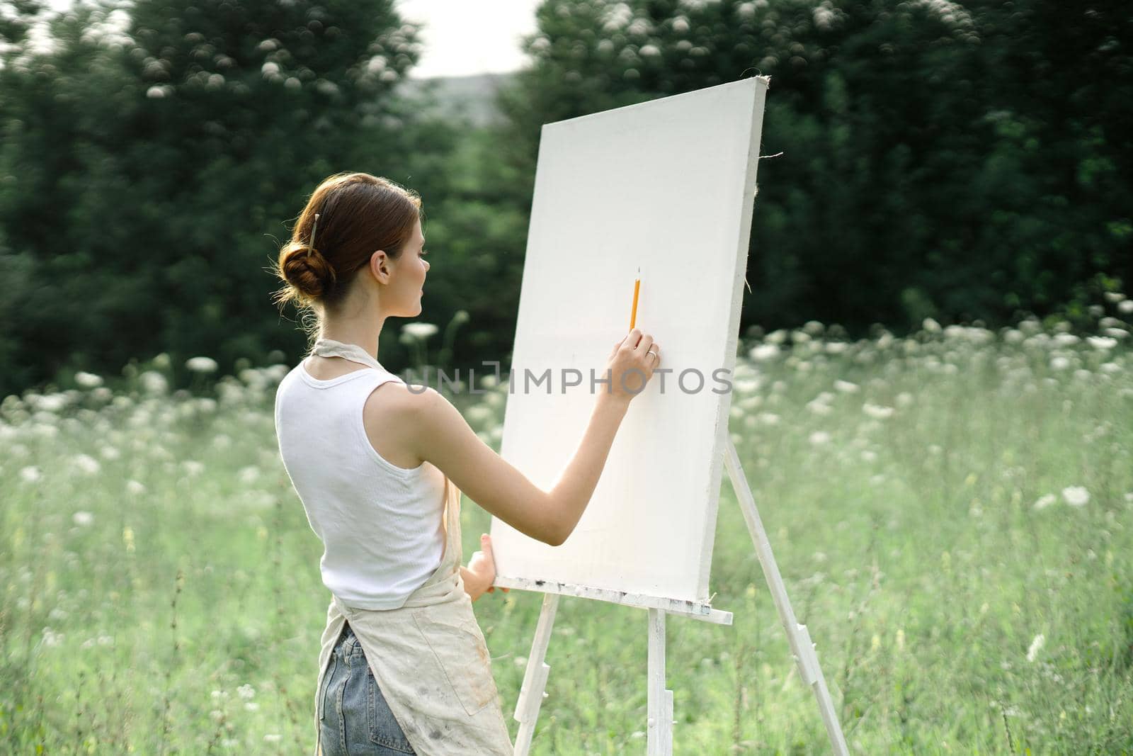 woman outdoors painting a picture creative art landscape. High quality photo