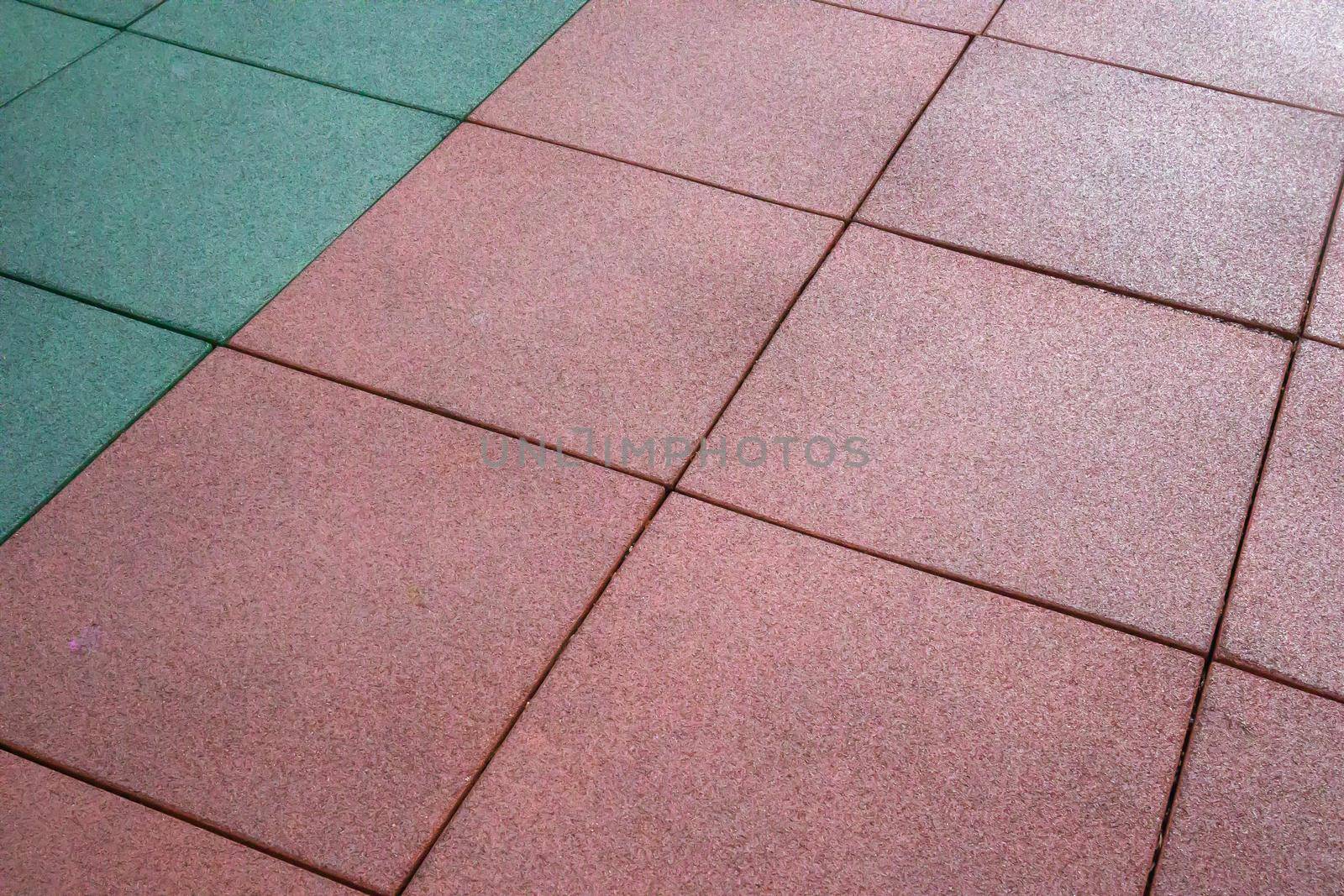 Artificial rubberized coating for playgrounds. Synthetic material. Colorful background of outdoor playground in rainy weather. Active lifestyle, workout concept