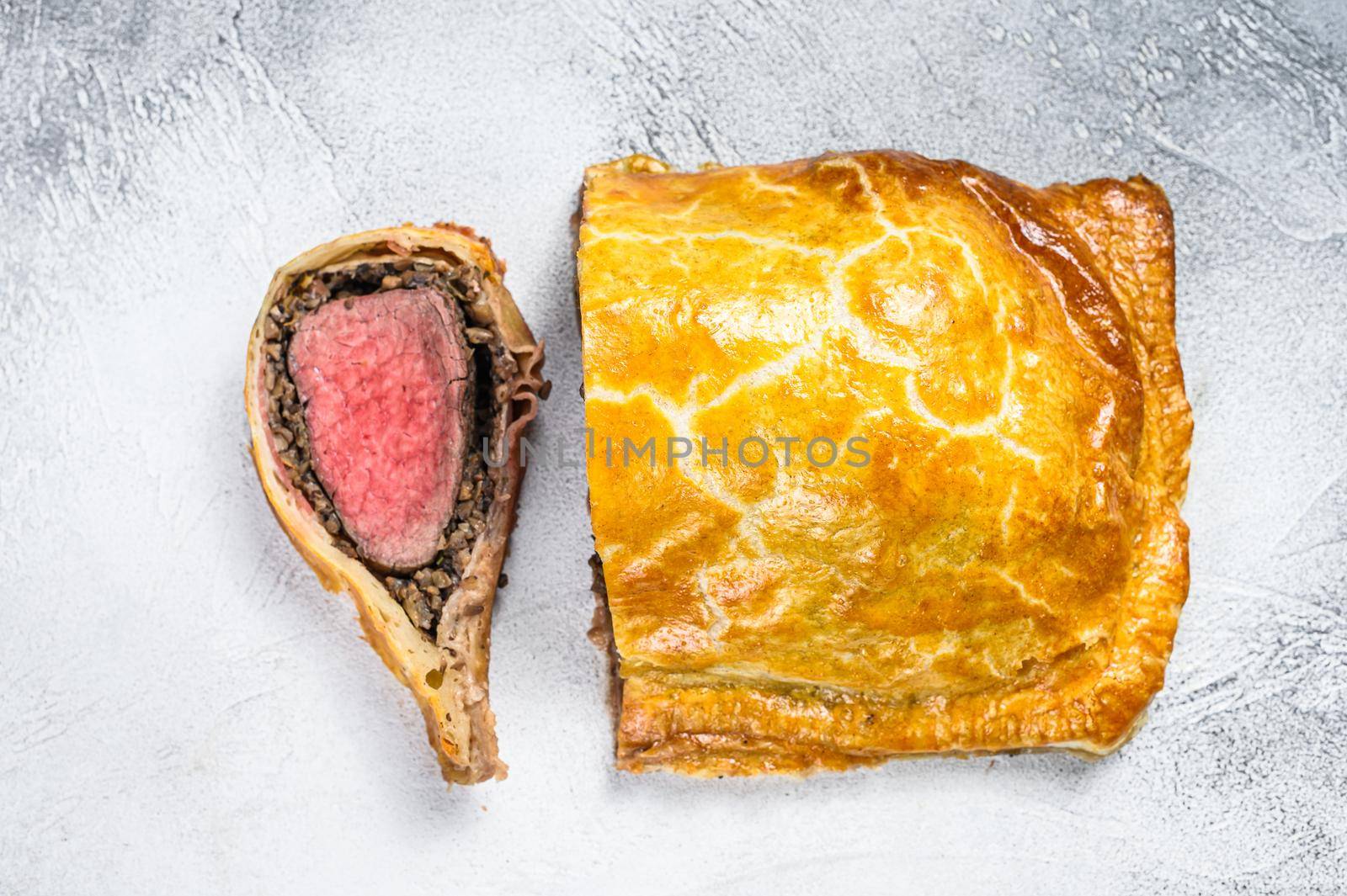 Beef Wellington puff pie classic steak dish with tenderloin meat. White background. Top view.