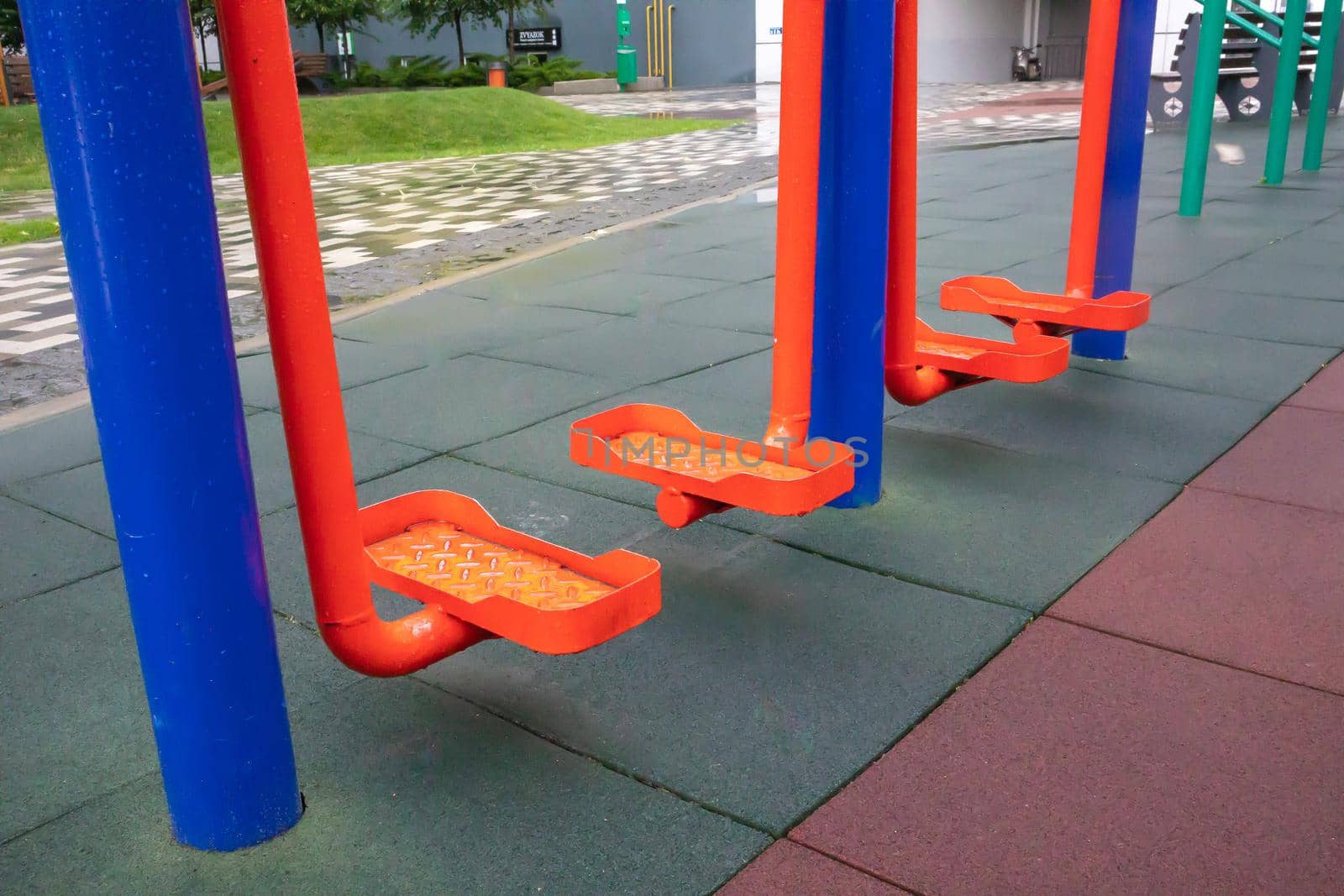Exercise machines and fitness equipment for exercising on an open air sports ground in cloudy rainy weather without people