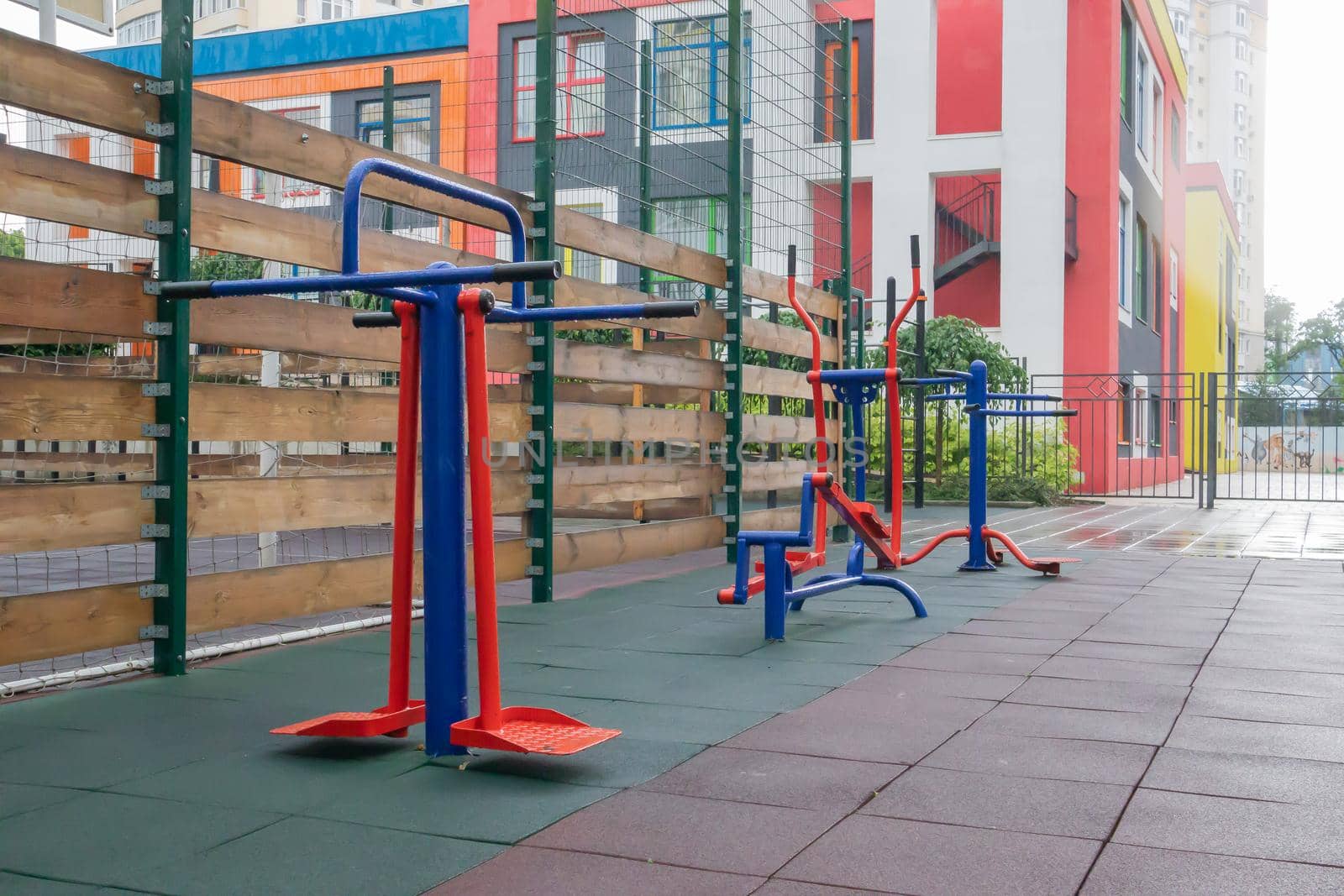 Exercise machines and fitness equipment for exercising on an open air sports ground in cloudy rainy weather without people